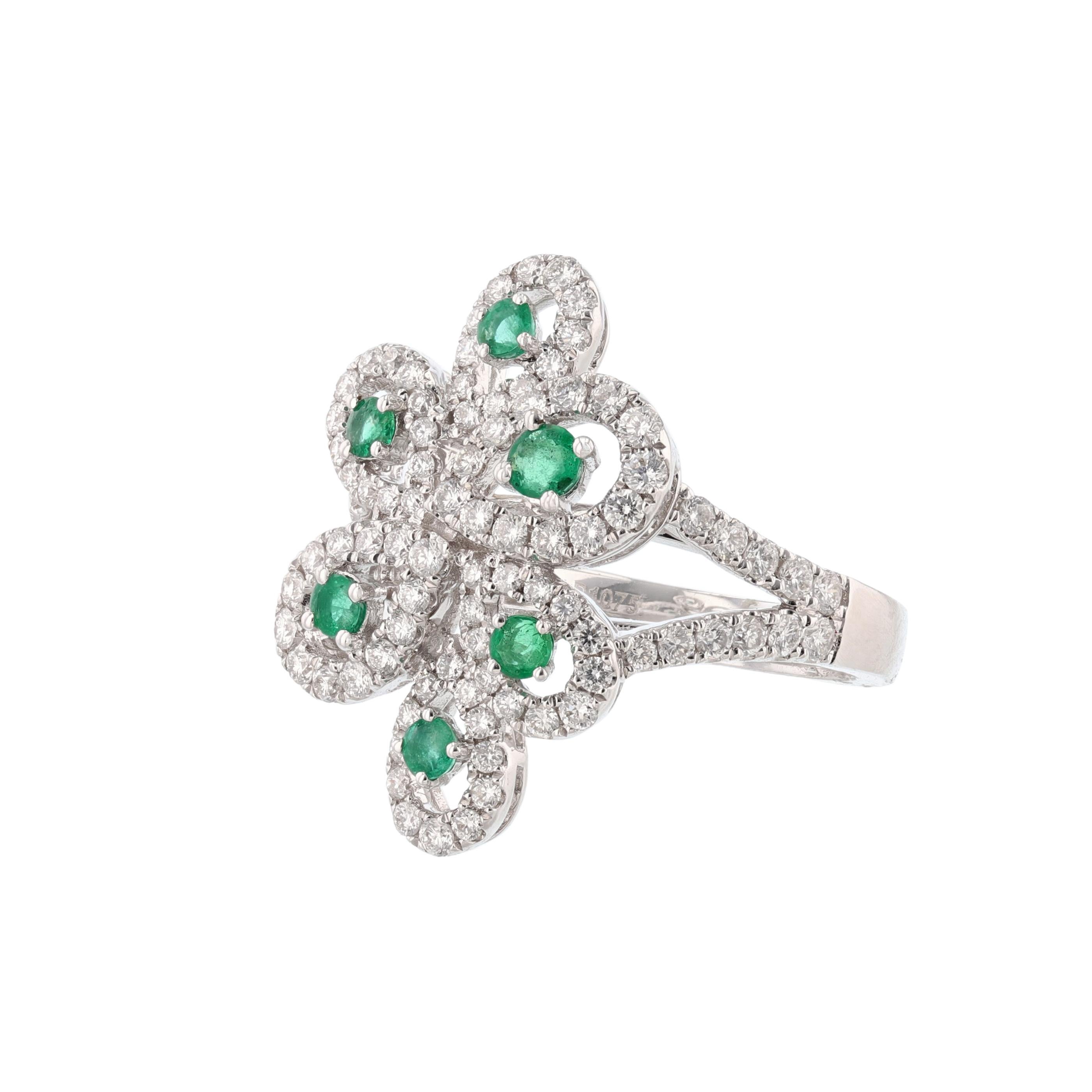 This ring is made in 18K white gold and features 6 round cut emeralds weighing 0.41 carat. Also, the ring features 96 round cut diamonds weighing 1.07 carat. With a color grade (H) and clarity grade (SI1). All stones are prong set. 