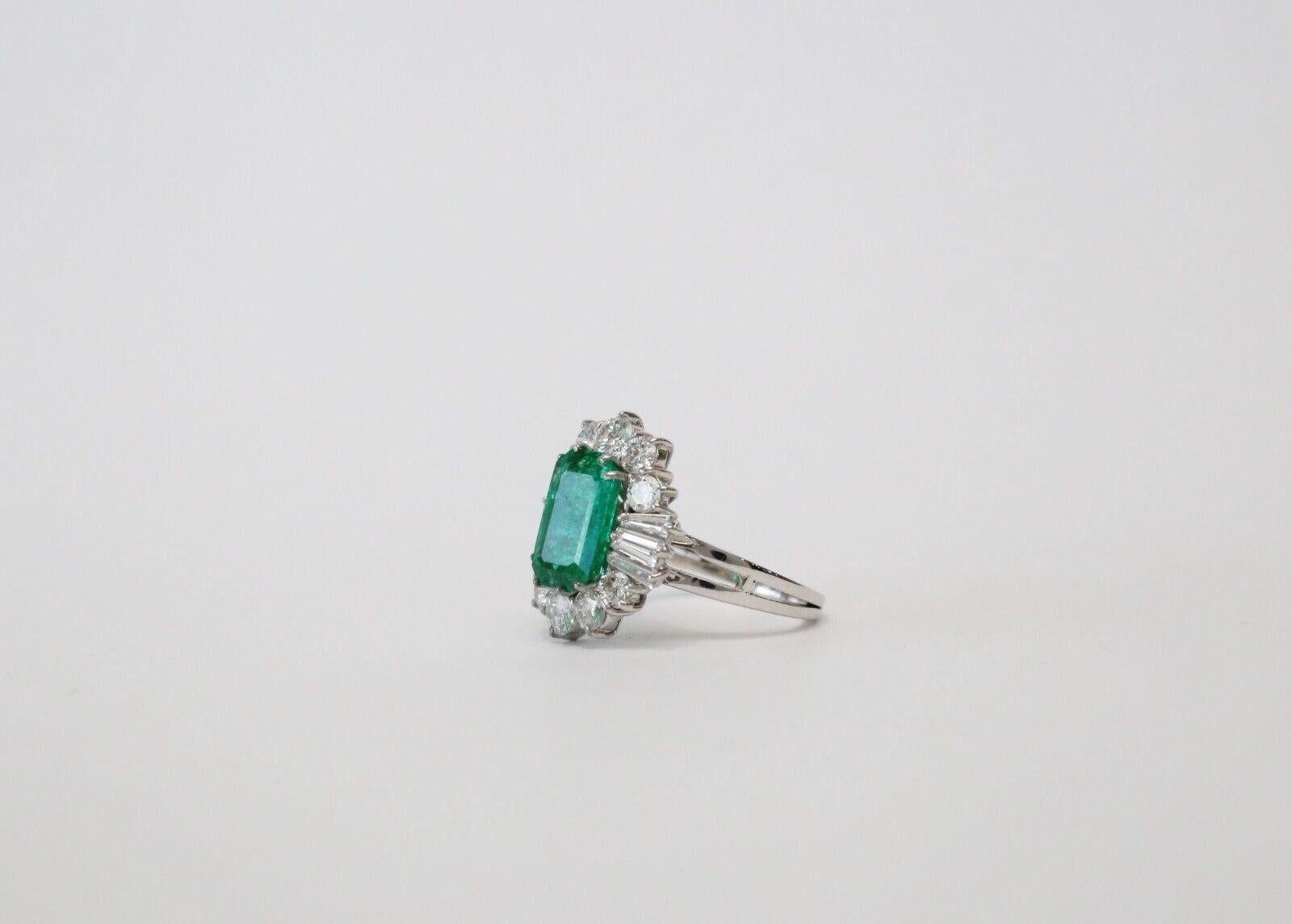 Add a distinctive ring with a striking gemstone contrast with this emerald and diamonds cocktail ring. Just stunning and crafted in 18k white gold with a tapered band, this lovely cocktail ring features a raised gemstone gallery. Supporting a large
