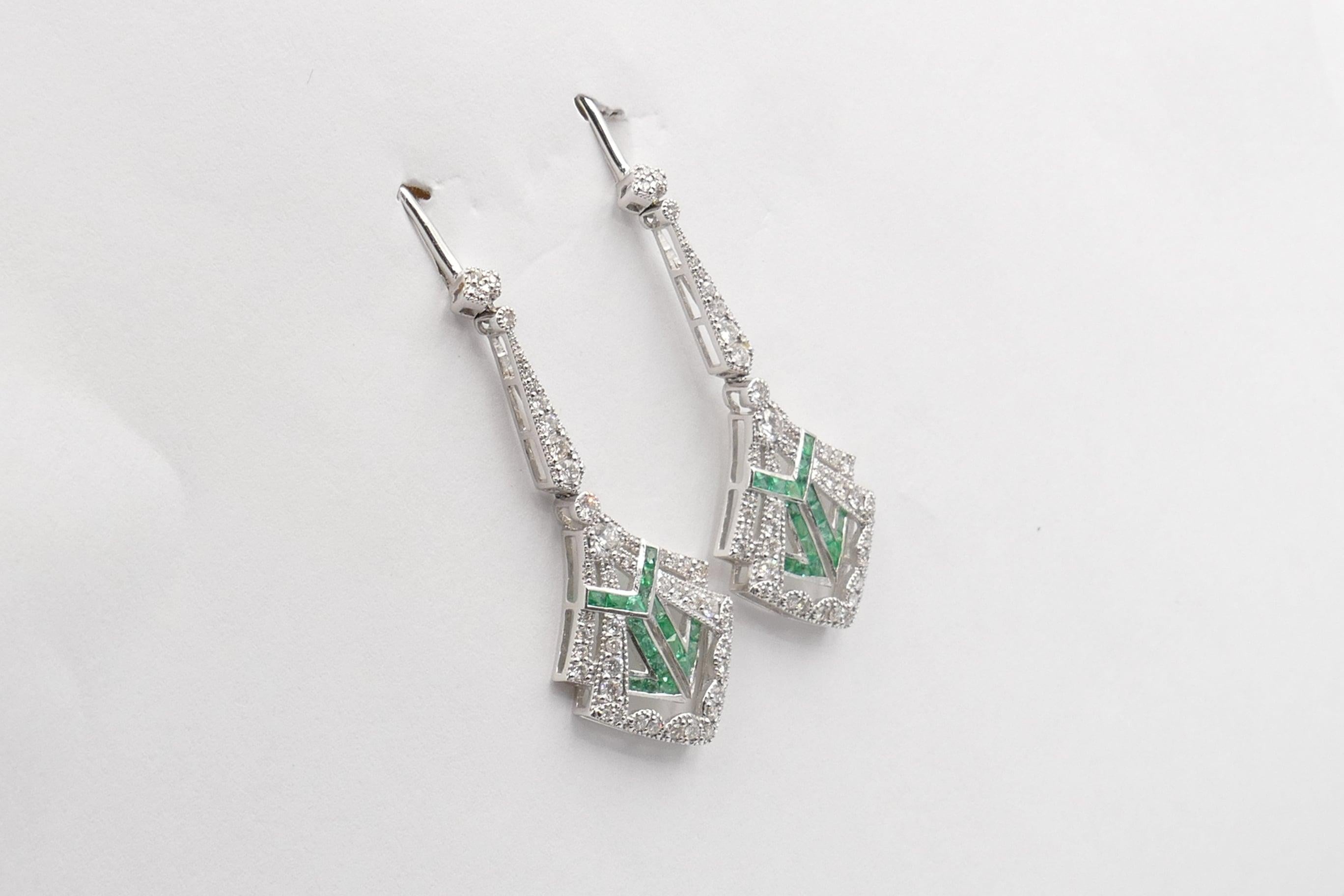 What a lovely design these gorgeous Earrings are. 
There are 36 Emeralds of bluish-green Colour, Medium Tone, Clarity eye-clean, French Carre Cut, Calibre Set that form the feature of these very versatile Earrings.
The Emeralds are surrounded by 86