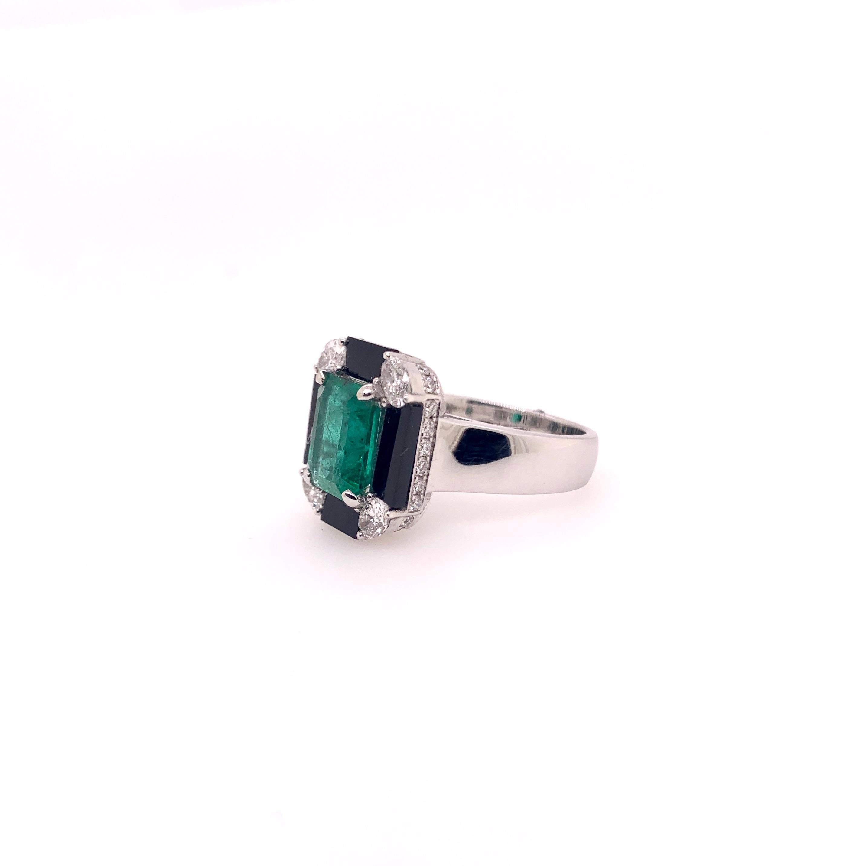 This stunning Zambian emerald and onyx combination cocktail ring will truly gather everyone's attention with this Art Deco look.   The oval diamonds in the corners give a nice accent to this handmade setting.  The custom cut onyx fits like a puzzle