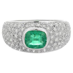 18K White Gold Emerald Ring Along with Clustered Diamonds 