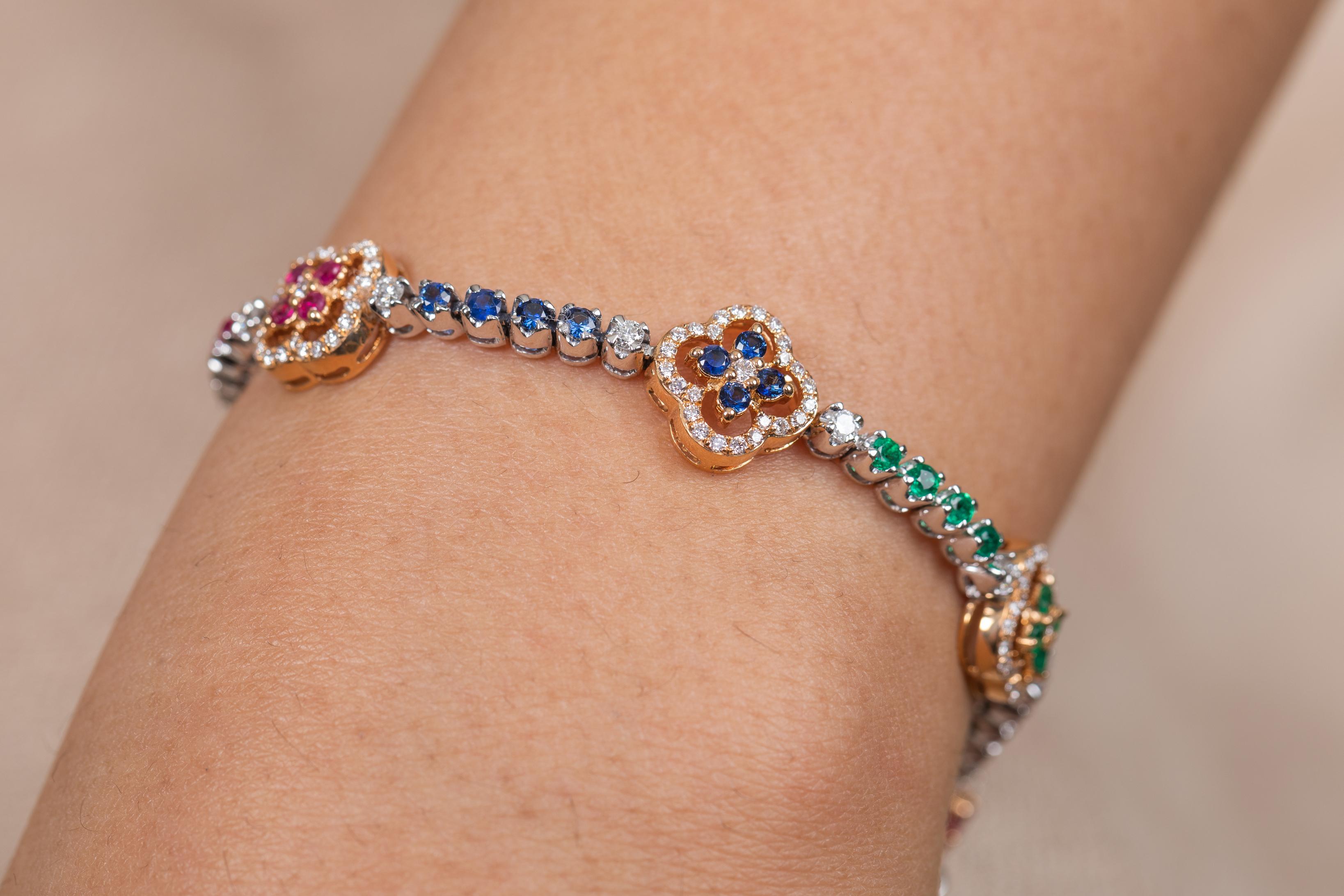 The wearing of charms may have begun as a form of amulet or talisman to ward off evil spirits or bad luck.
This emerald , ruby , blue sapphire bracelet has a round cut gemstone and diamonds in 18K Gold. A perfect piece of jewelry to adorn your