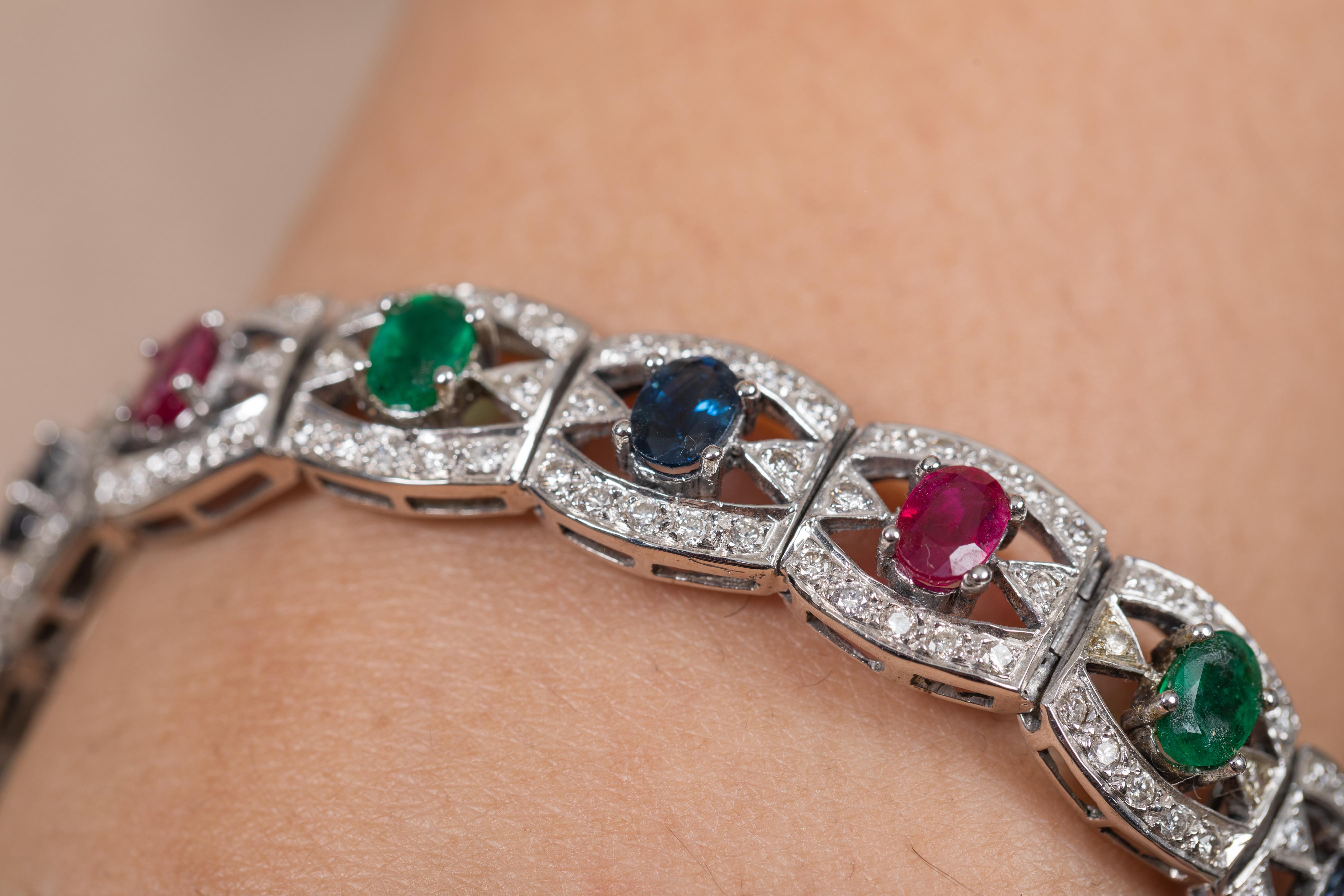 The wearing of charms may have begun as a form of amulet or talisman to ward off evil spirits or bad luck.
This emerald, ruby, blue sapphire bracelet has a oval cut gemstone and diamonds in 18K Gold. A perfect piece of jewelry to adorn your jewelry