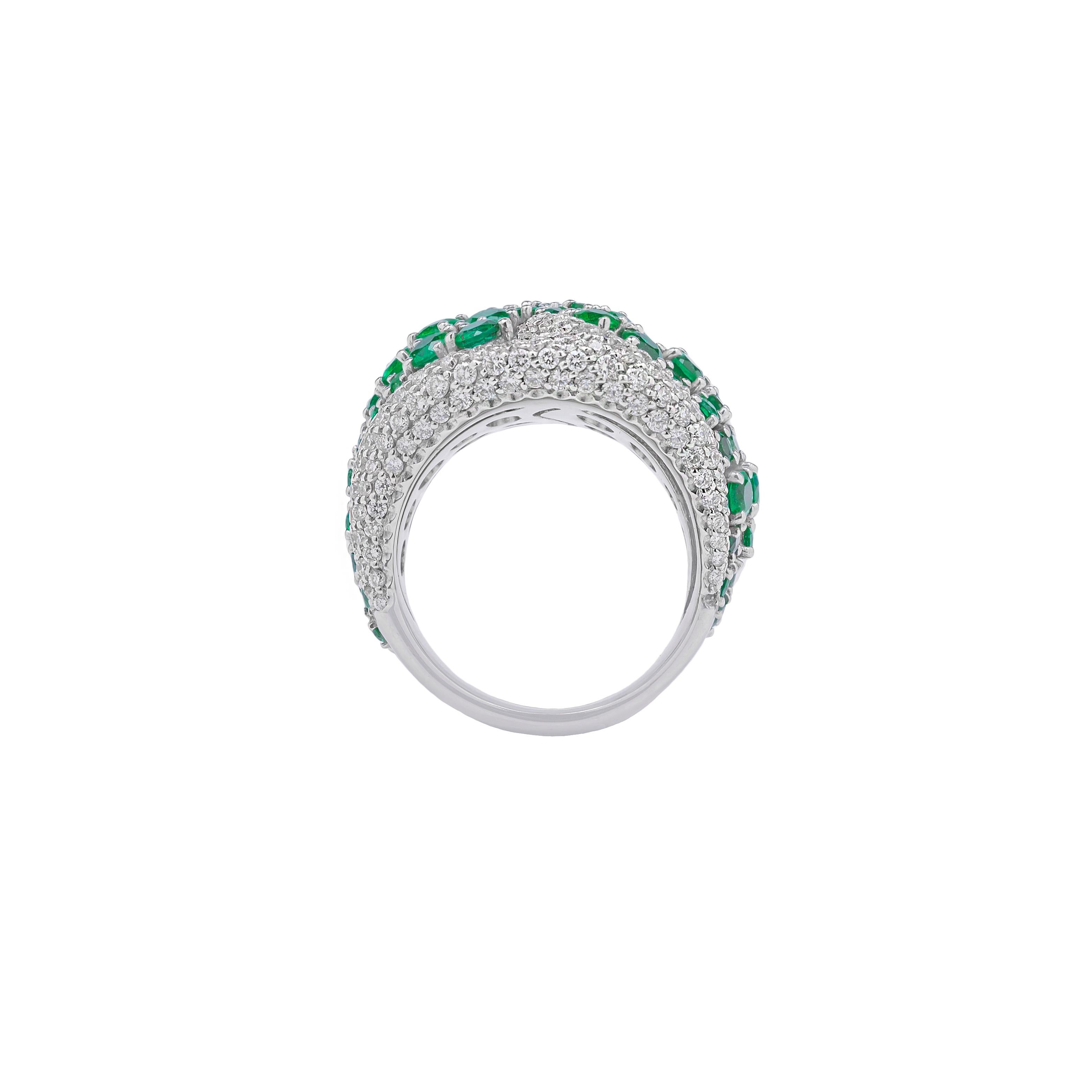 This ring is made in Italy by Fanuele Gioielli.
It has a rounded band shape beautifully decorated by brilliant cut emeralds surrounded by brilliant cut white diamonds. 

Emerald total content is 3.74ct
Diamonds total content is 2.16ct
18k Gold total