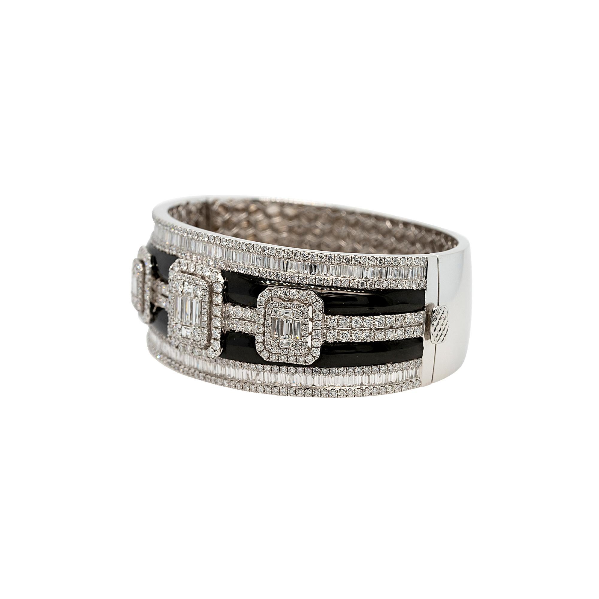 Material:
18k White Gold
Black Enamel
Diamond Details:
5.41ct Round Brilliant Natural Diamond
4.05ct Baguette Cut Natural Diamond
G color VS Clarity
Measurements: 
Size 6
26.5mm x 7.2mm
Total Weight: 65.8g (42.3dwt)
This item comes with a