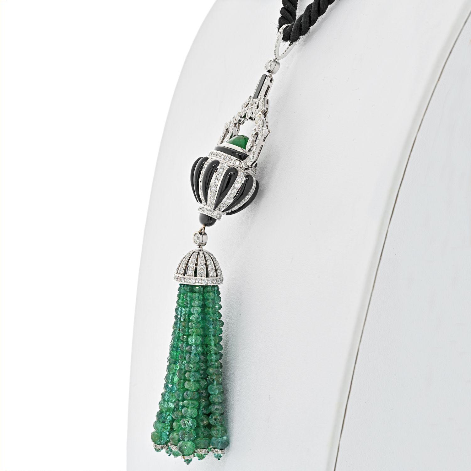 This fine 18k white gold necklace on a black cord features all natural emerald beads, diamonds and onyx accents made in a shape of a tassel. Styled in Art Deco fashion this tassel necklace is in excellent condition. Measures about 4 inches long,