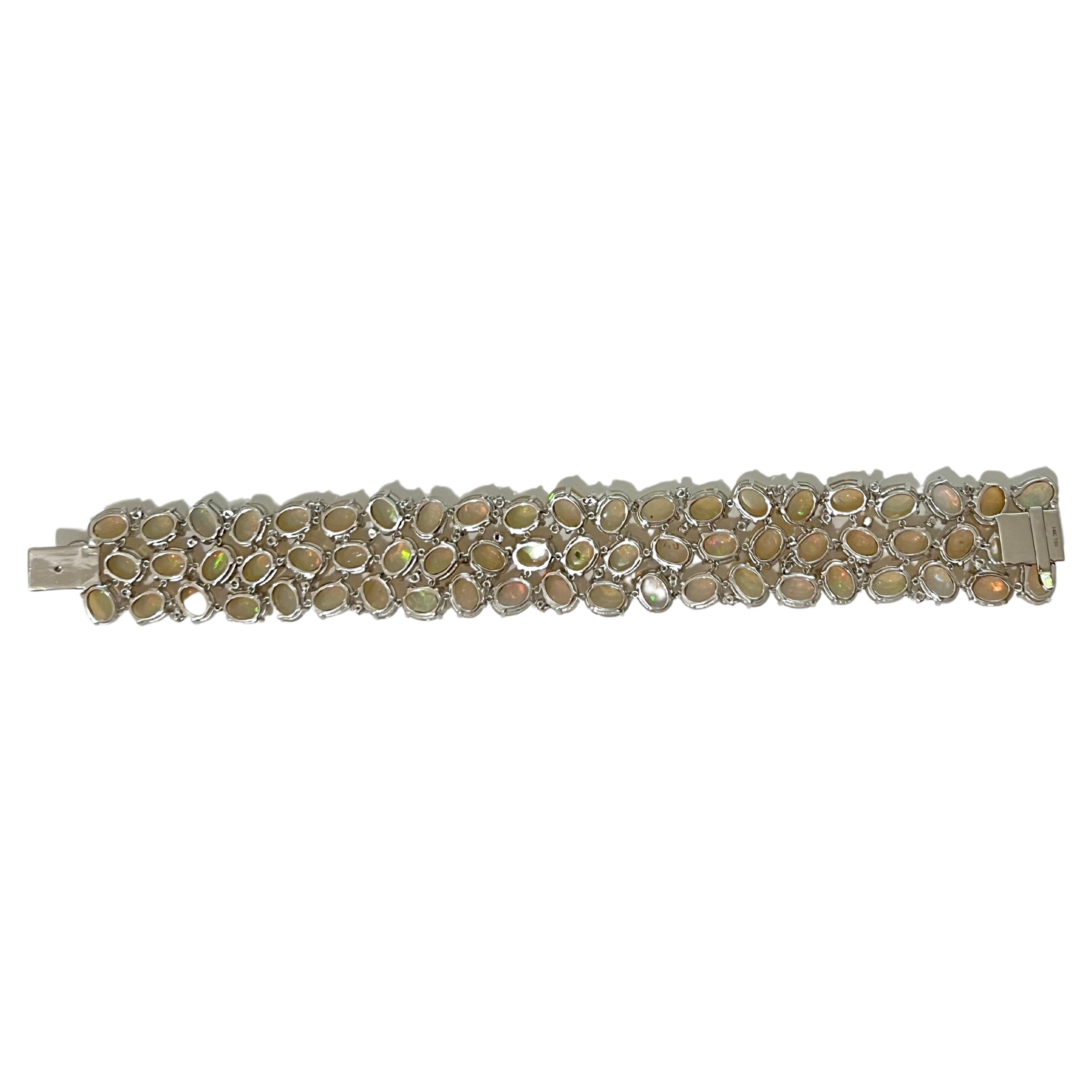 This gorgeous Ethiopian bracelet has diamonds sprinkled throughout to make this mini cuff style pop.  The bracelet is 1 inch width, and will complement any outfits as the colors in the opals range from red, blue-green, and orange.  The setting is