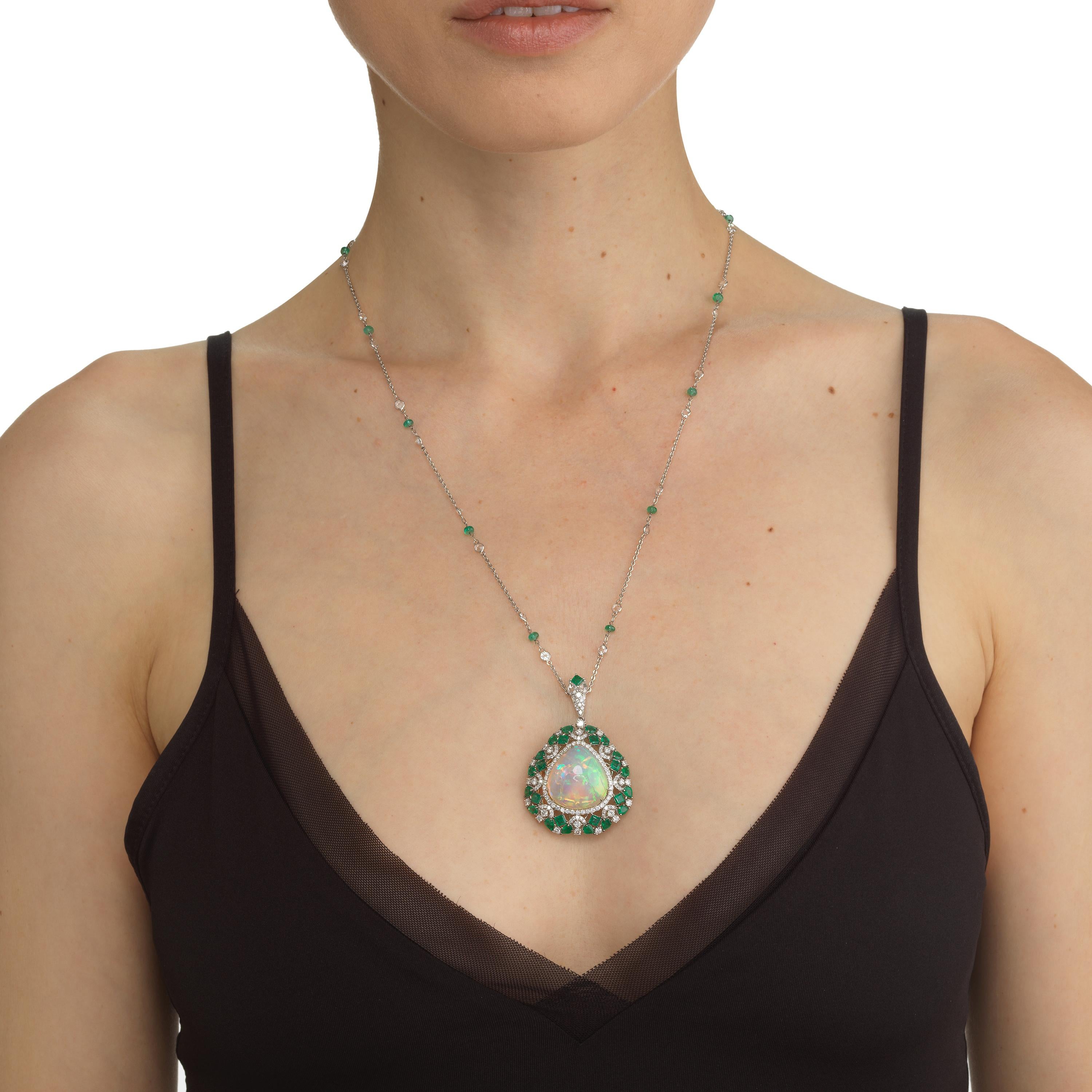 Adorn your neckline with this gorgeous pendant necklace. This necklace comes with 1 Ethiopian opal, 28 emerald and 217 pave diamonds. Crafted in 18K white gold this pendant necklace is a must have.
JEWELRY SPECIFICATION:
Gross Weight: 22.69