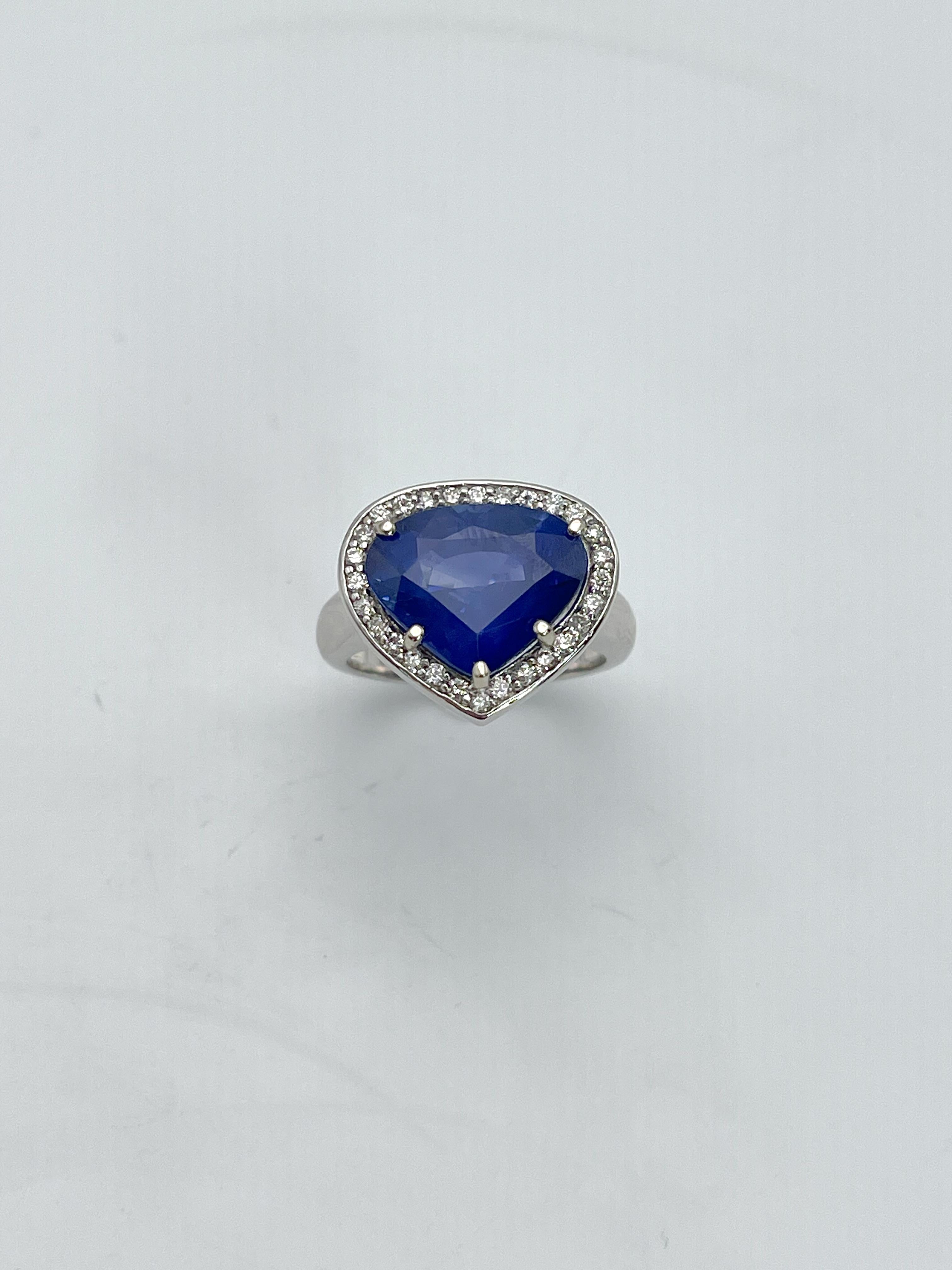 This unique women's fashion ring was crafted using 18k white gold, a soft 11x13 fancy cut BlueSapphire with a rich royal blue color set in a halo with round diamonds that make the sapphire stand out.
Will fit size 6 1/2 finger.

