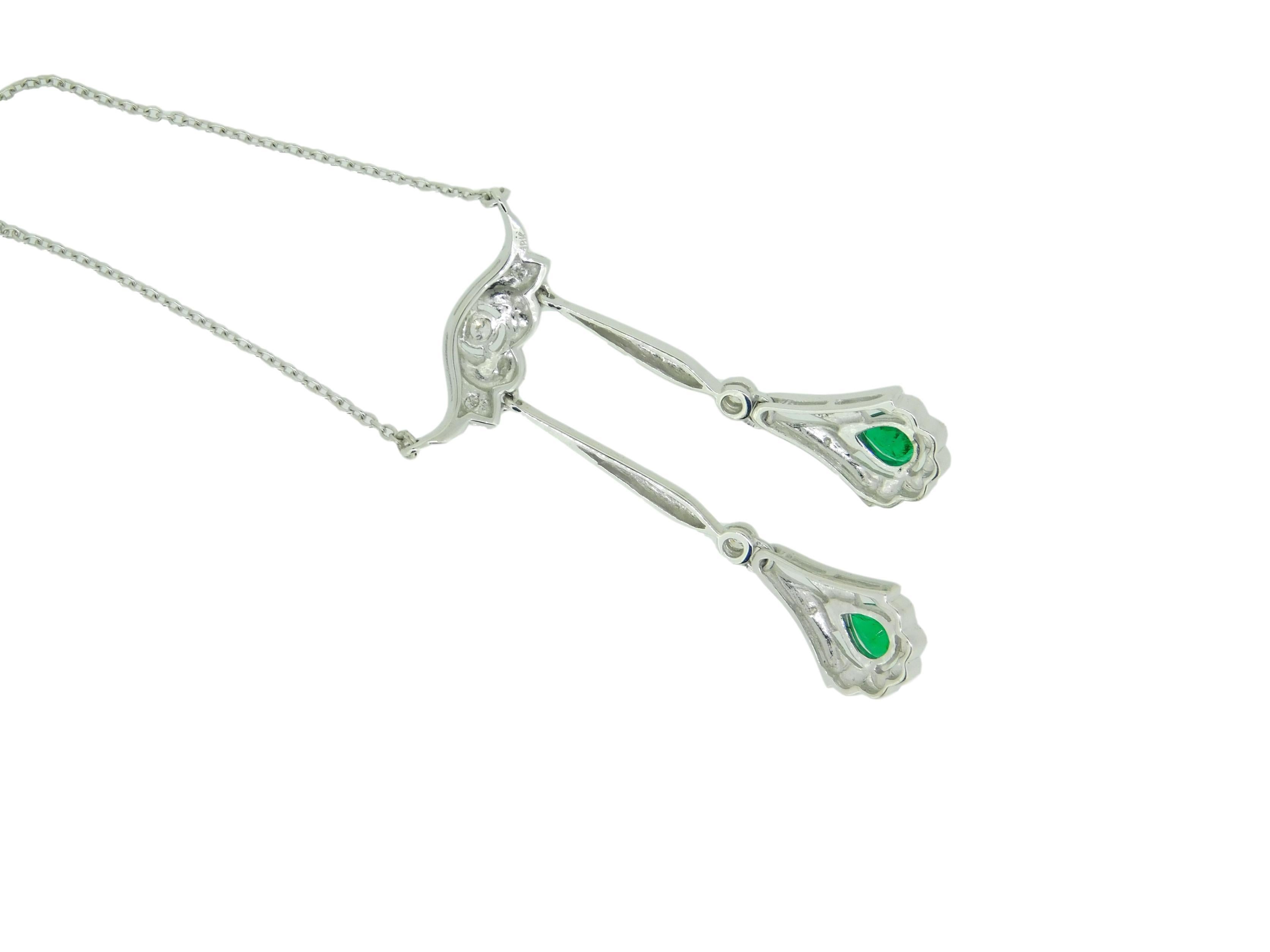 18k White Gold Fancy Drop Genuine Natural Emerald and Diamond Necklace (#J4719)

18k white gold necklace featuring two drops with pear shape emeralds weighing .54cts total. The emeralds are fine quality and have medium dark green color. The emeralds