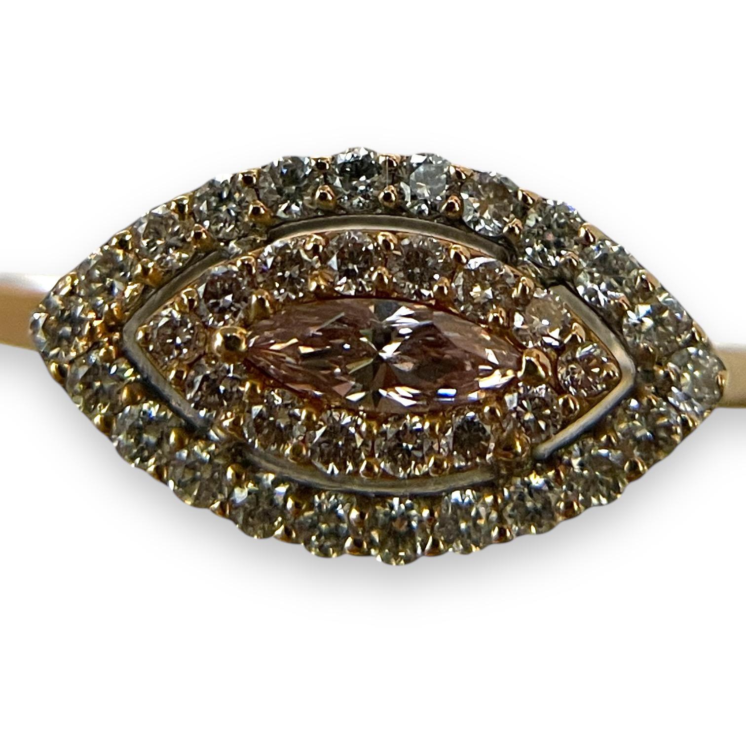 This piece is perfect for a night out with friends or a family event. Made out of 14k yellow gold and inlaid with a marquise-cut diamond, the ring is durable enough to handle daily usage. The design features a double halo of smaller round diamonds,
