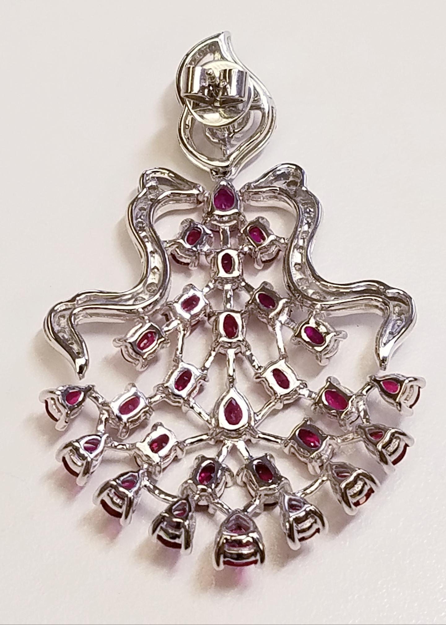 18k White Gold Fancy Ruby and Diamond Earrings 
12.86 Carats of Rubies
1.83 Carats of Diamonds
In this design there is a mix of Oval and Pear Cut Rubies
18 Karat White Gold 