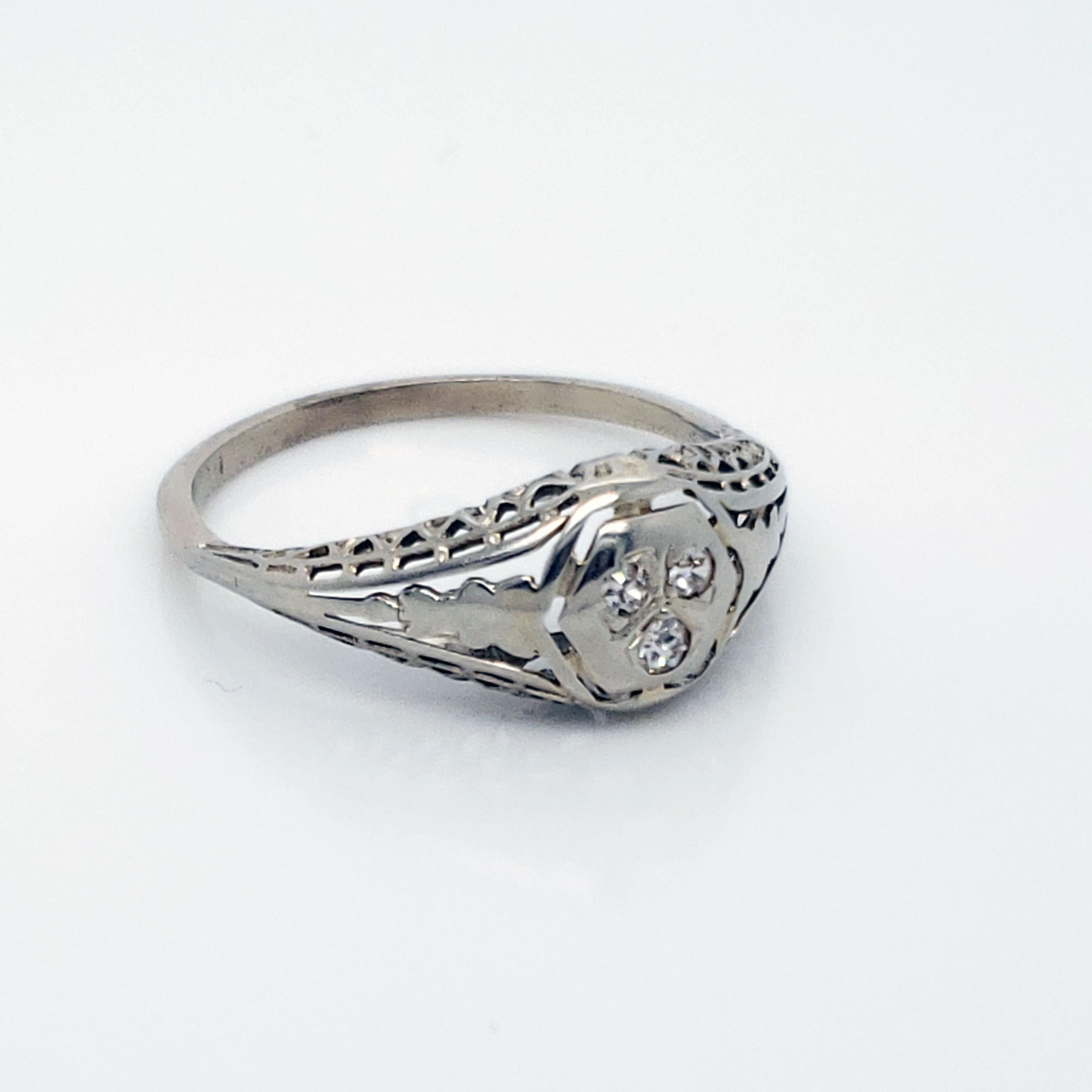 This ring is positively gorgeous! Dated to the 1920s, this lovely ring is fashioned from real 18K white gold and three genuine European Cut diamonds! The filigree detail in this ring will have everyone swooning! The unique look of this lovely