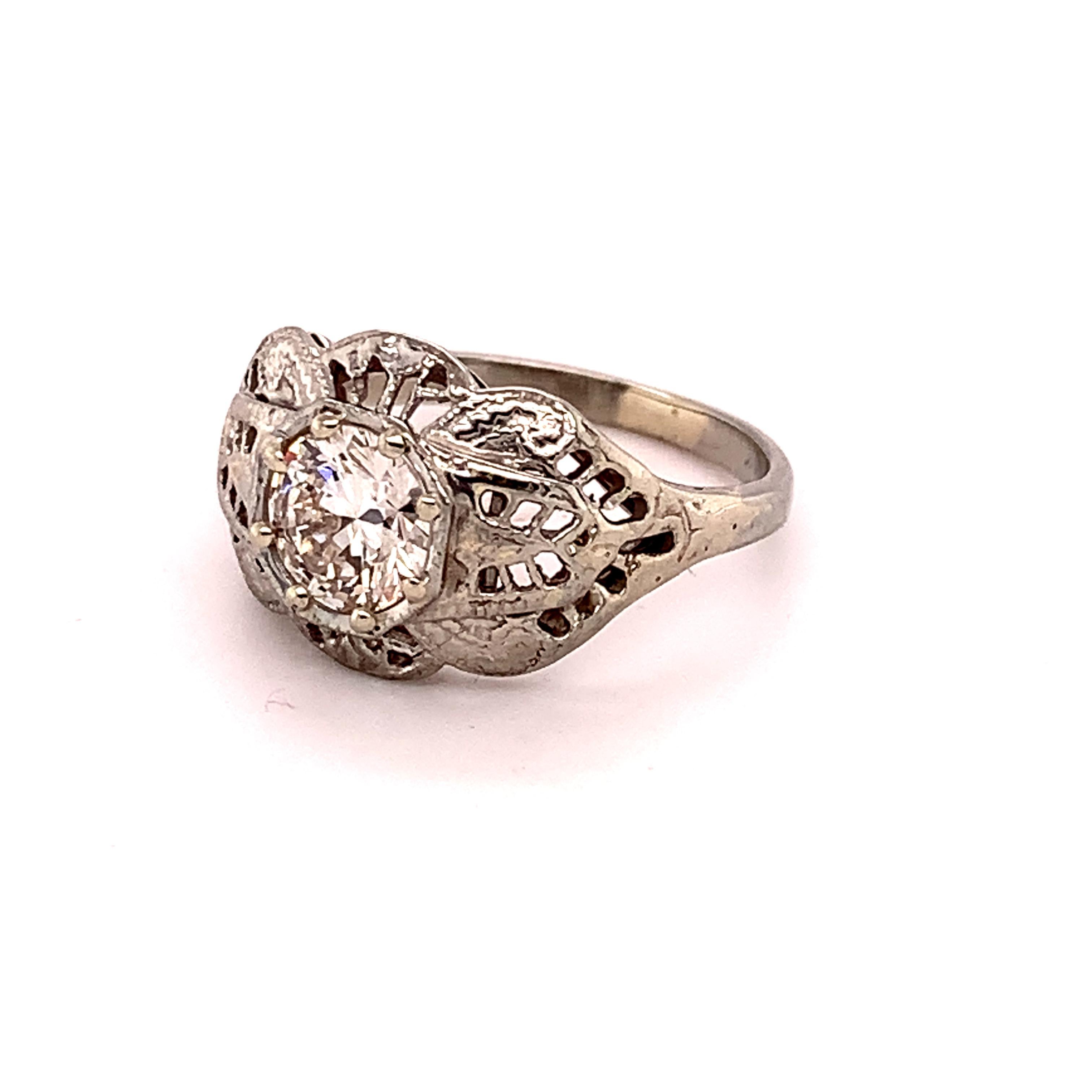 18k White Gold Filigree Art Deco .60ct Genuine Natural Diamond Ring (#J4895)

Art Deco 18k white gold filigree ring featuring a round brilliant cut diamond weighing .60cts. The diamond has VS clarity and I-J color and measures about 5.5mm. The ring