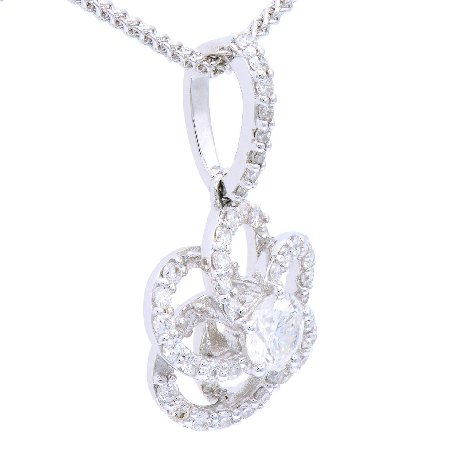 This gorgeous pendant contains 54 beautiful round VS2, G color diamonds, with a total of .43 carats, shaped into a flower. The sapphires total 0.93 carats. They are set in 1.21 grams of 18 karat white gold and has an 18 karat white gold chain