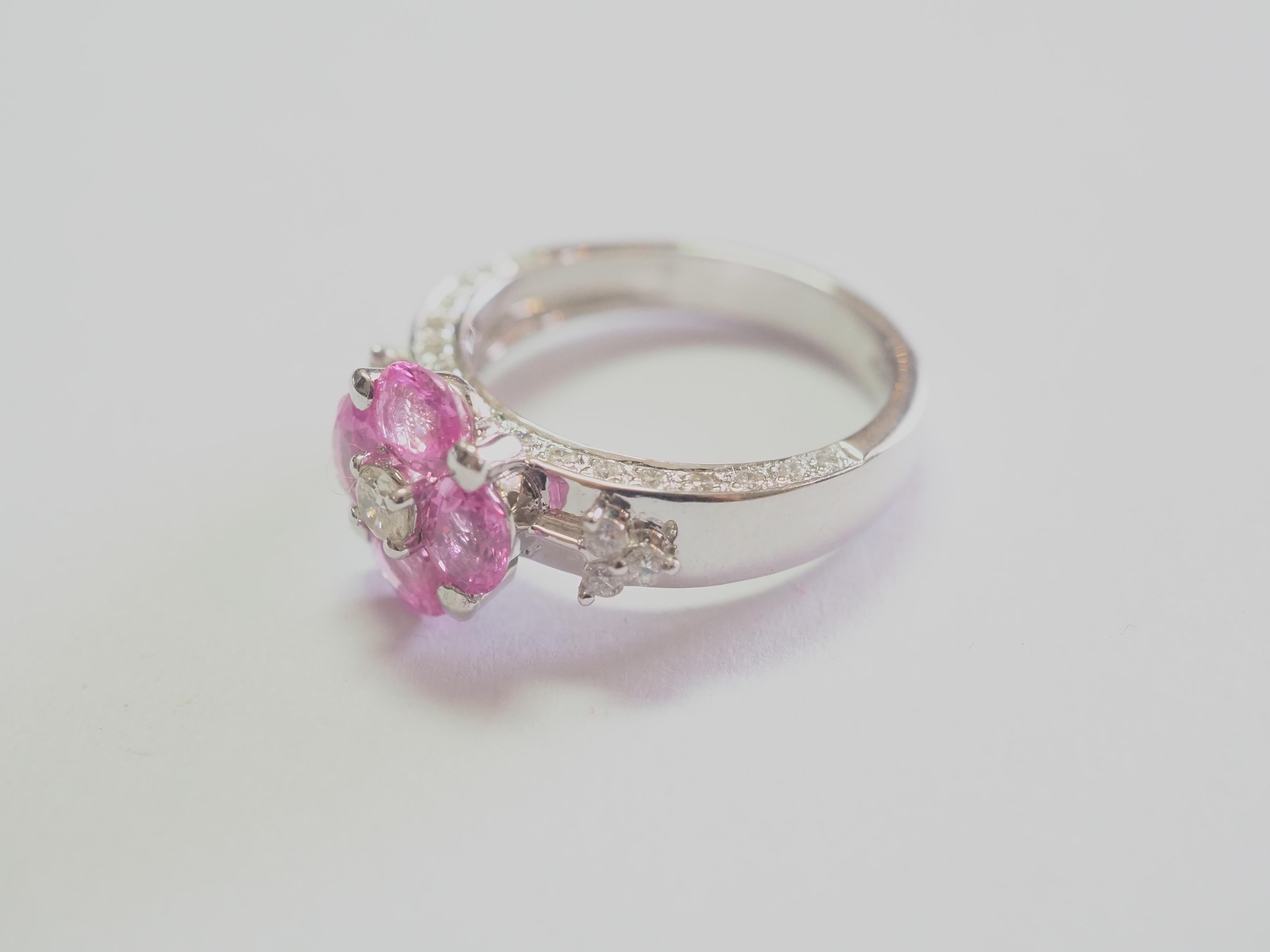 This flowery and beautiful engagement piece is an 18K white gold fine quality pink sapphire and diamond ring. 4 bubblegum oval pink sapphires are set meticulously and all the same size with matching colors. There are 6 of round cut diamonds which is