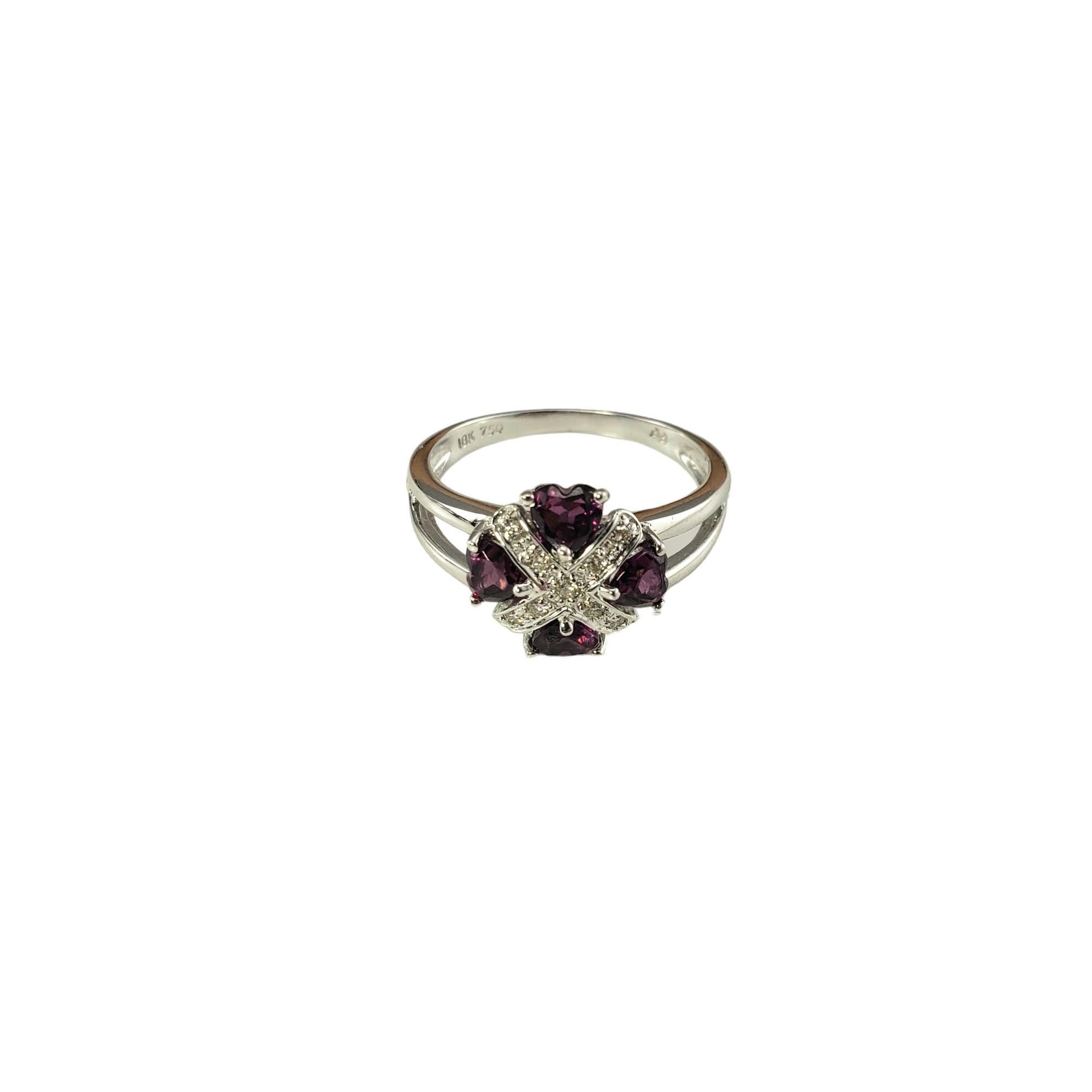 18K White Gold Garnet and Diamond Ring Size 7 JAGi Certified-

This lovely ring feature four heart shaped garnets and nine round brilliant cut diamonds set in classic 14K white gold.  Width: 11 mm.  Shank: 2 mm.

Total garnet weight: 1.08

Total