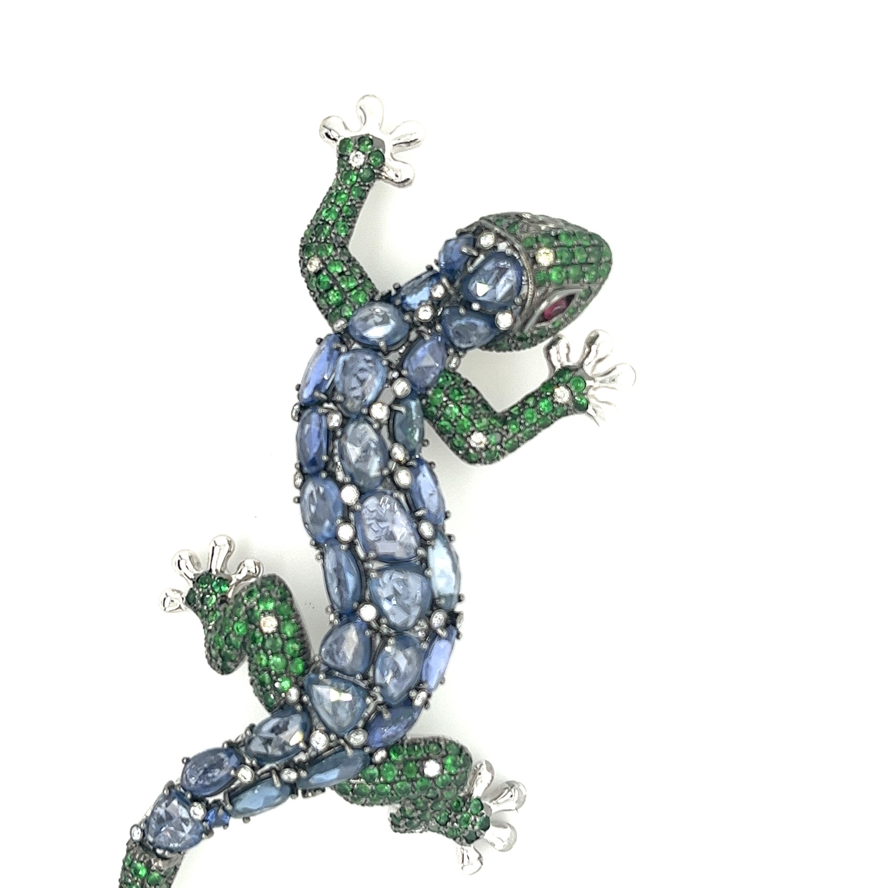 18K White Gold Gecko Brooch with
Diamonds & Blue Sapphires
 & Green Garnets
43 Diamonds - 0.39 CT
28 Blue Sapphires - 13.67 CT
232 Green Garnets - 3.76 CT
2 Rubies - 0.10 CT
18K White Gold - 22.82 GM
Introducing our exquisite 18K White Gold Gecko