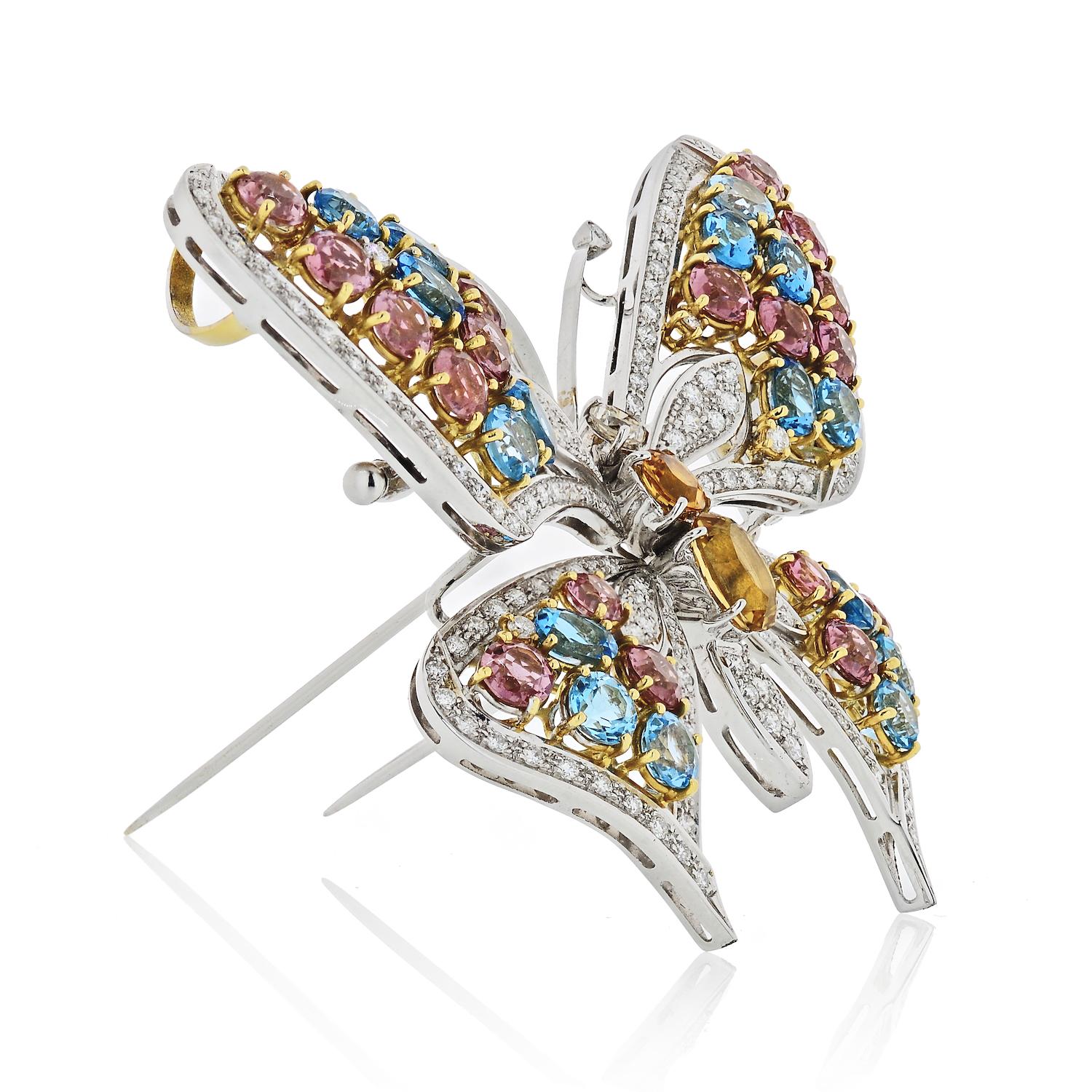 Multicolored gemstone and diamond brooch in the form of a butterfly, with the wings set with diamonds and multicolor gemstones. Total diamond weight estimated 4 carats, total gemstone weight estimated 10 carats, to a white gold mount. Made in