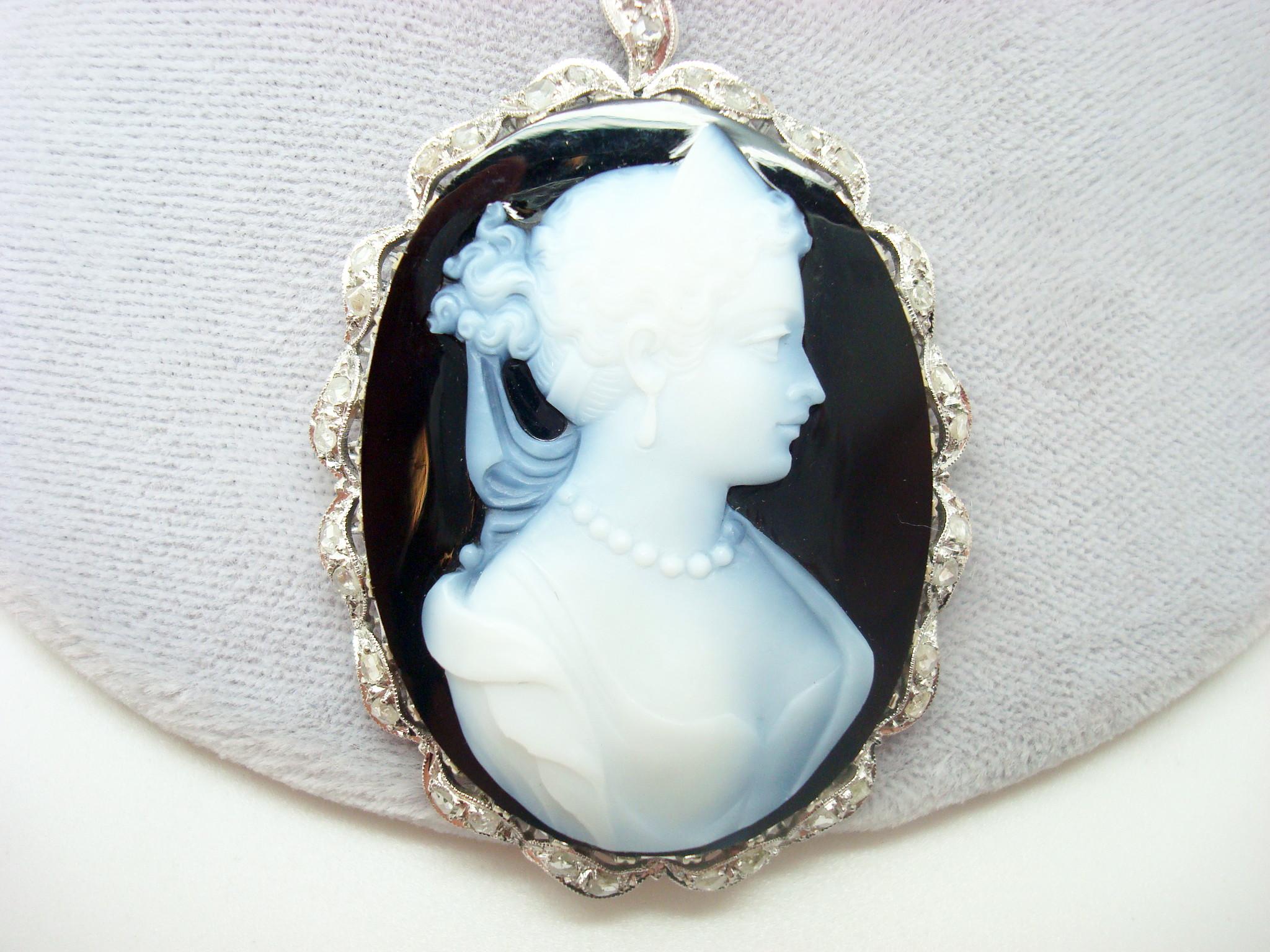18k White Gold Genuine Natural Agate Stone Cameo Diamond Pendant (#J2463)

18k white gold black and white hard stone cameo pendant. It is finely made and it features a large oval black and white banded agate stone cameo. The cameo measures about
