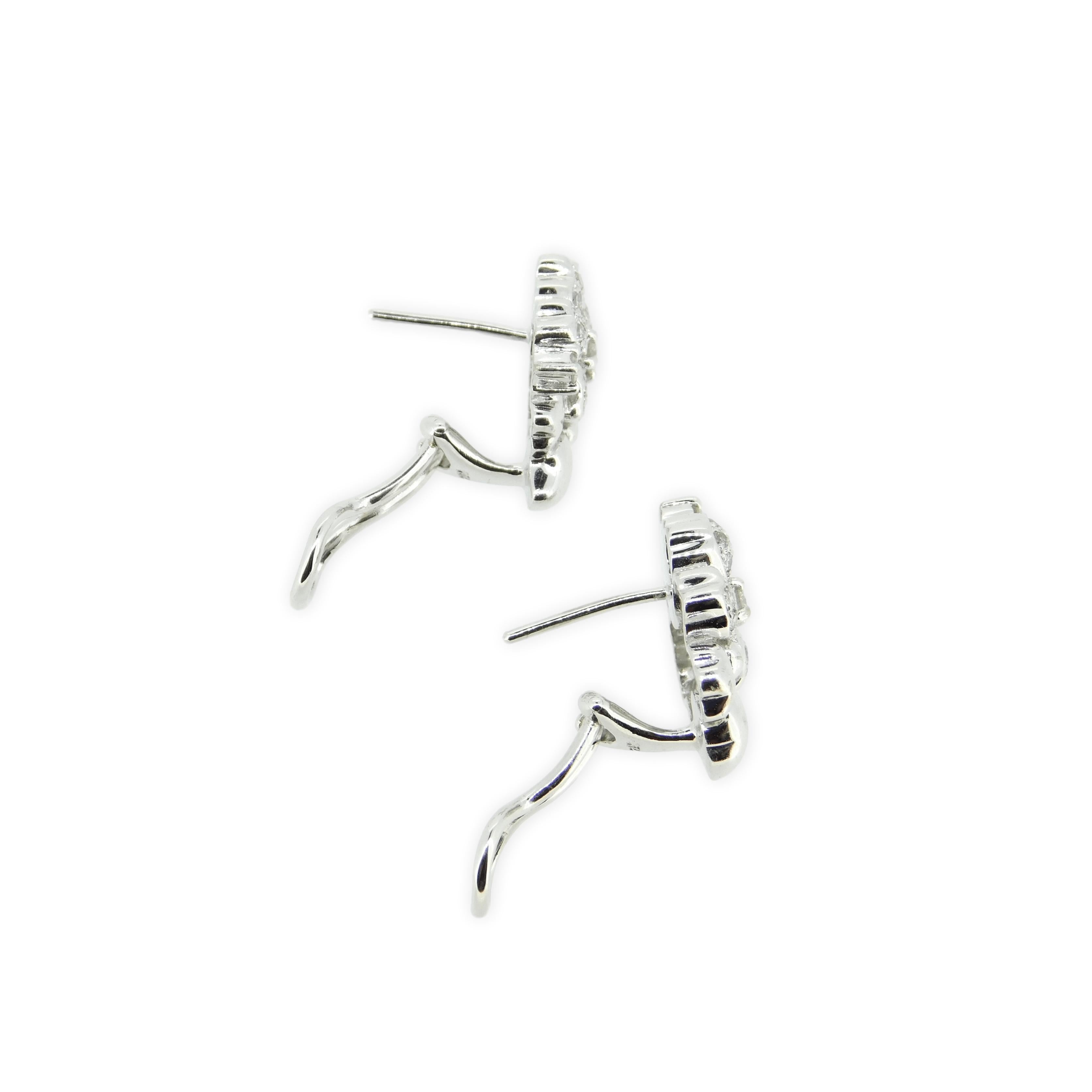 18k White Gold Genuine Natural Diamond Flower Earrings 1.2 Carats (#J1779)

18k white gold diamond earrings in the form of a flower featuring 1.2 carats of round brilliant cut diamonds. The three larger diamonds are prong set, and the surrounding