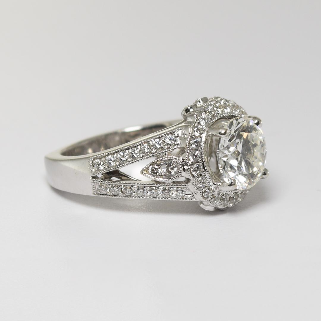 Ladies 18k white gold and diamond engagement ring.
Stamped 18k and weighs 8.2 grams.
The center diamond is a 2.01 carat round brilliant cut, I color, Vs2 clarity, and excellent cut grade.
The edge of the diamond is inscribed GIA 1172349610 report