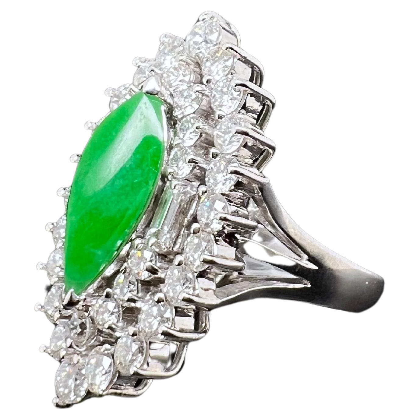 This phenomenal ring has a natural jadeite surrounded by round brilliant diamonds and baguettes set in 18k white gold. The elongated jadeite has a gorgeous glow stand outs amongst the bright, white diamonds. Natural Jadeite is not easy to come by