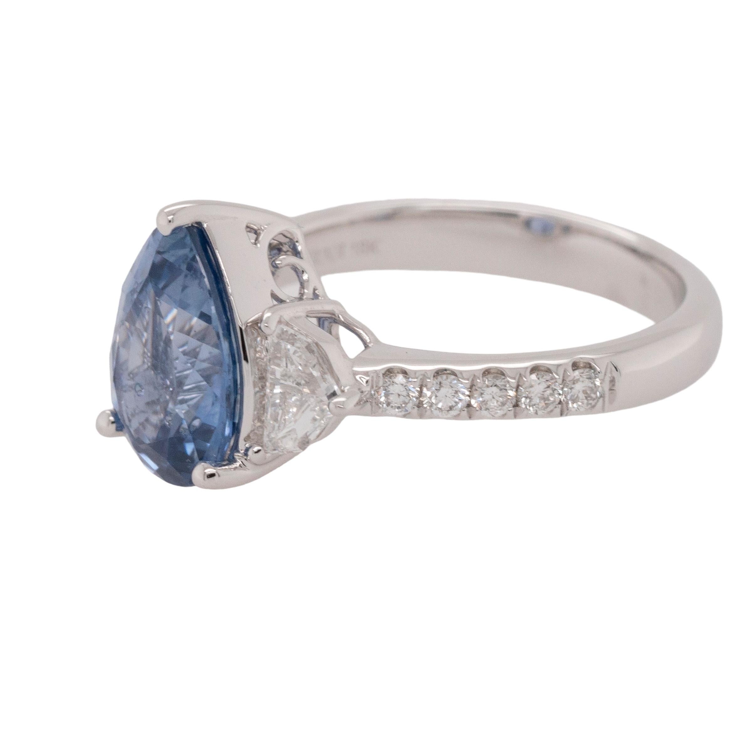 This stunning 18k White Gold ring showcases a captivating blend of 2.96ctw Natural Round Brilliant and Epaulette-cut diamonds paired with a 2.26ctw heated Sapphire. The ring features 0.23ctw Round Brilliants and 0.47ctw Epaulette-cut diamonds, all