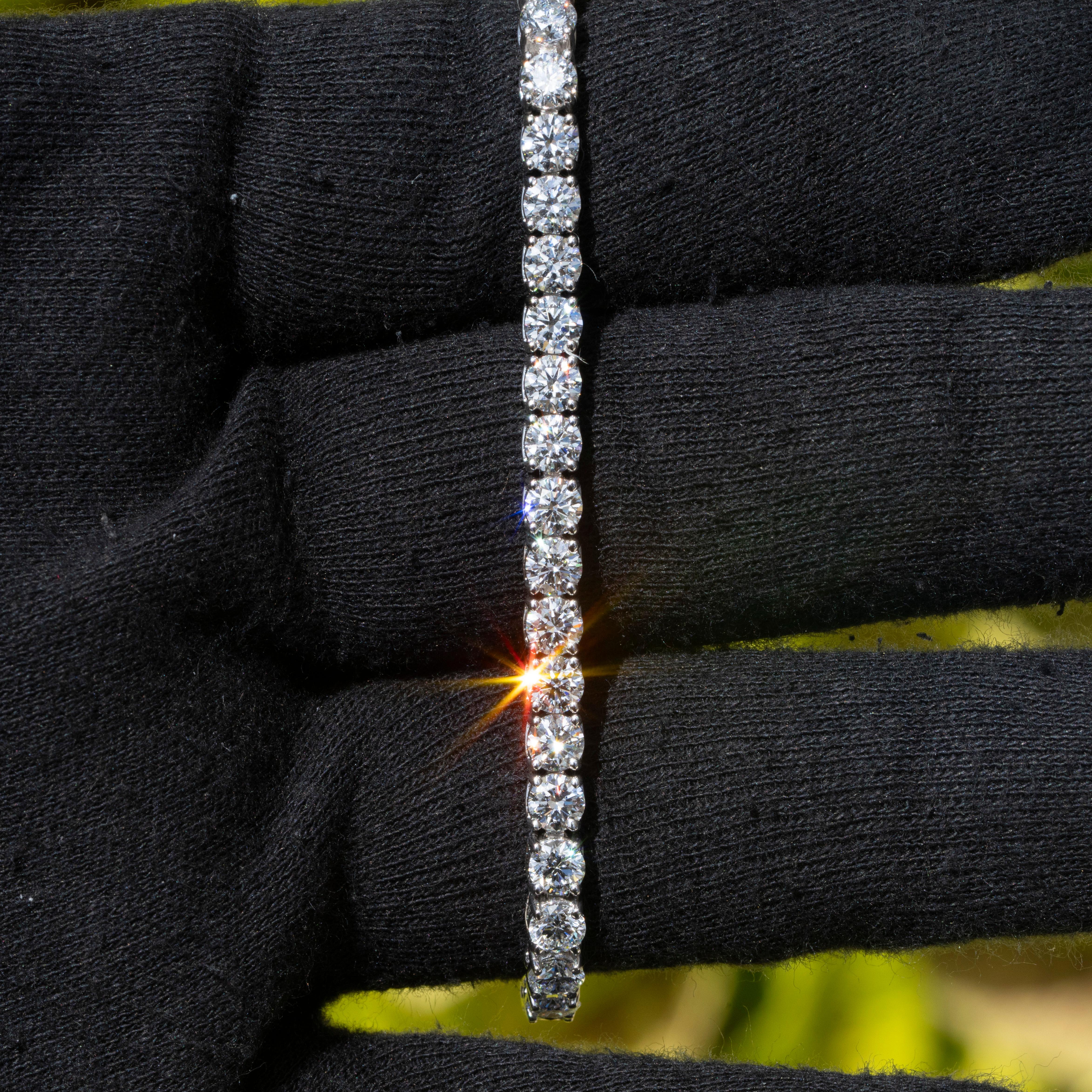 This luxurious 18k white gold tennis bracelet features 10.5 carats of natural round brilliant diamonds. The diamonds are GIA certified with D color and Internally Flawless clarity, and are graded Excellent for cut, polish, and symmetry. Weighing