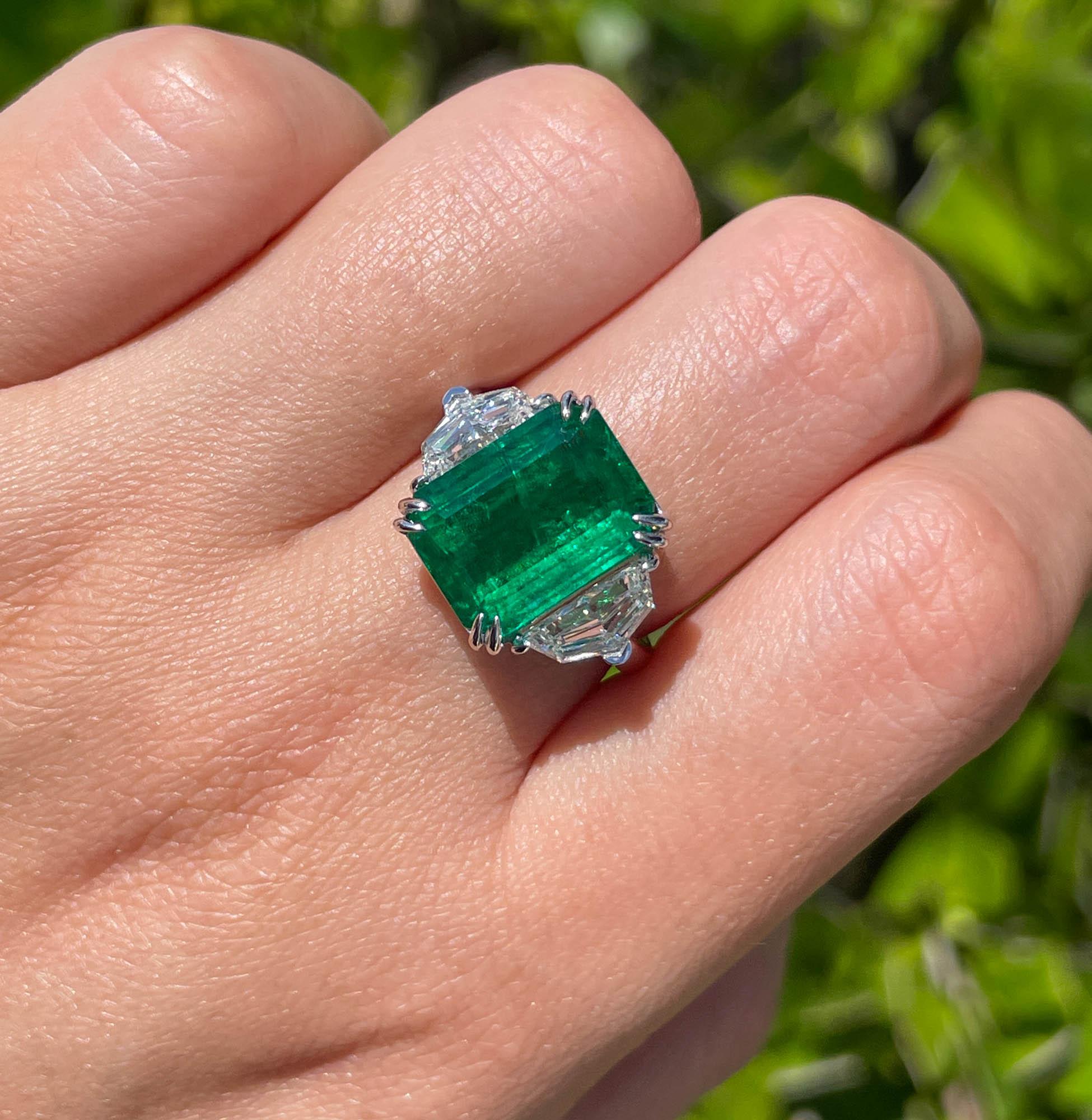 Classic 18k White Gold Green Emerald and Diamond Three Stone Engagement Right Hand Ring 
The center stone is Natural Step Cut Green Emerald; total weight is 6.45ct.
It is set with 2 large Cadillac shaped side diamonds; estimated weight is 1.30ctw;