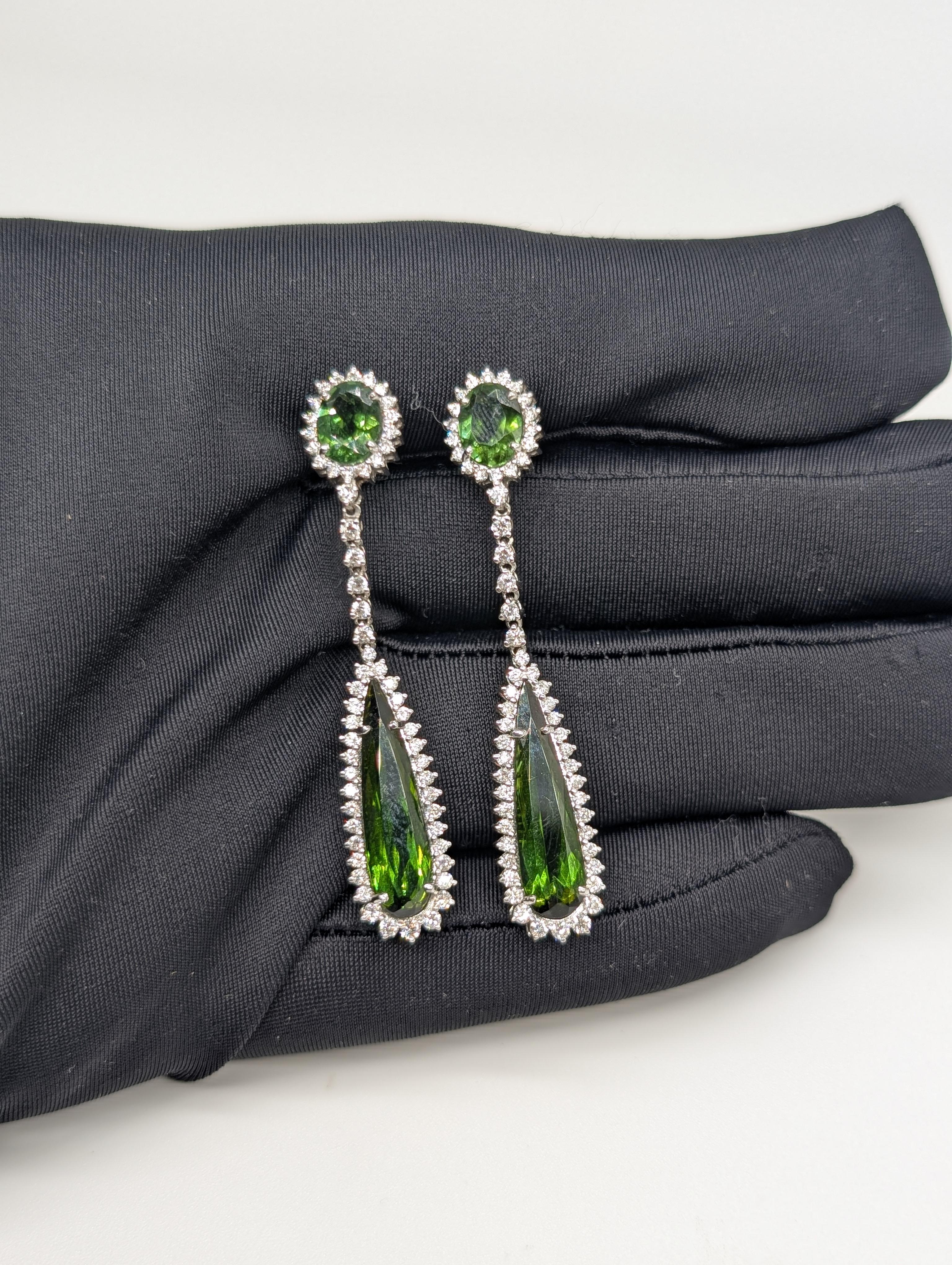 These exquisite drop earrings are crafted in 18-karat white gold and feature stunning green tourmalines (11.80ct) as their focal point. The vibrant green gemstones are elegantly complemented by sparkling diamonds (1.42ct), adding a touch of