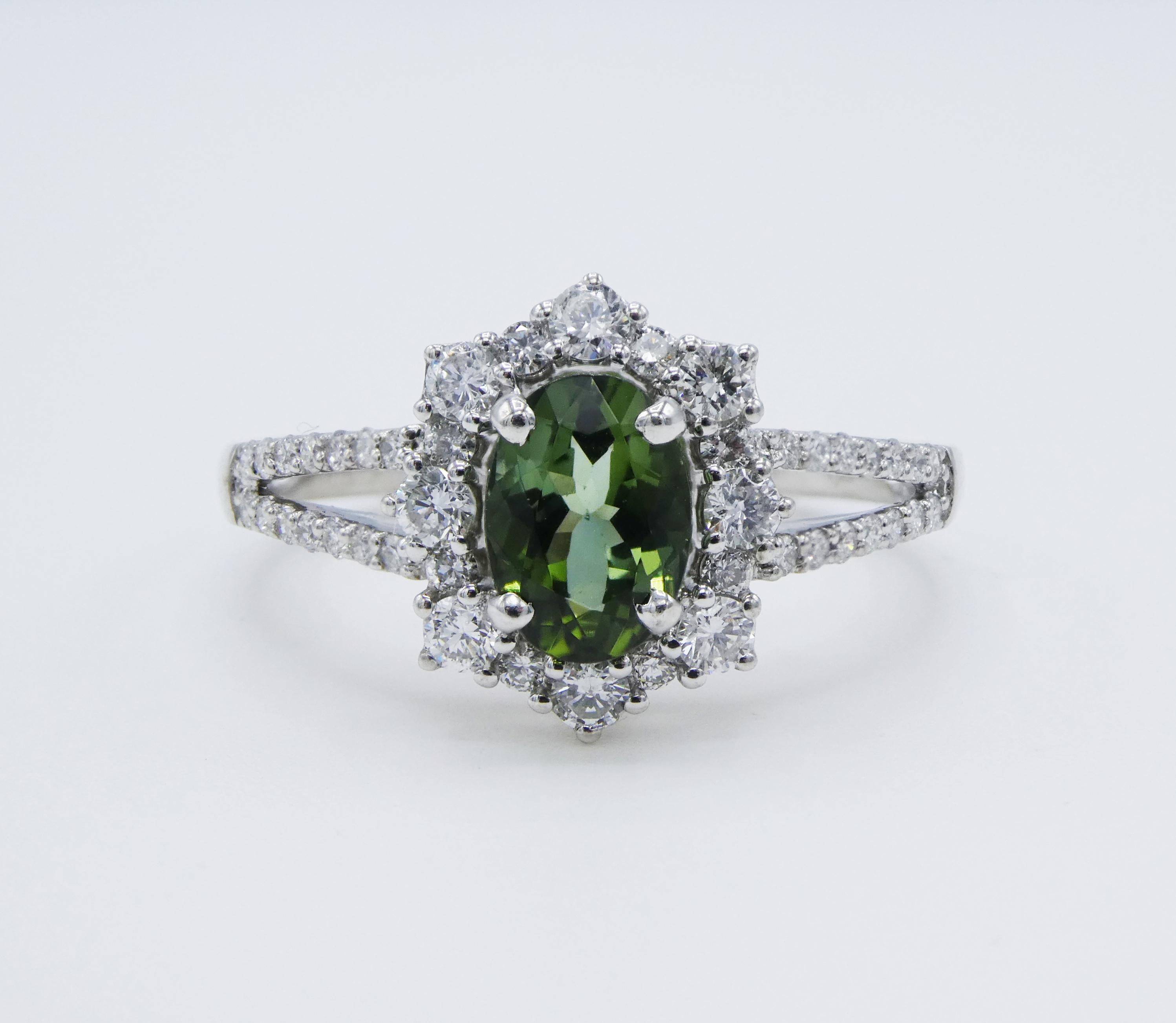 0.75ct Tourmaline Diamond Ring 18k White Gold Halo Style Split Shank Size 7

Metal: 18k White Gold
Weight: 3.57 grams
Tourmaline: approx. 0.75 carat oval 7 x 5mm
Diamonds: 0.47 carats total weight G VS
Ring size: 7
Markings: 