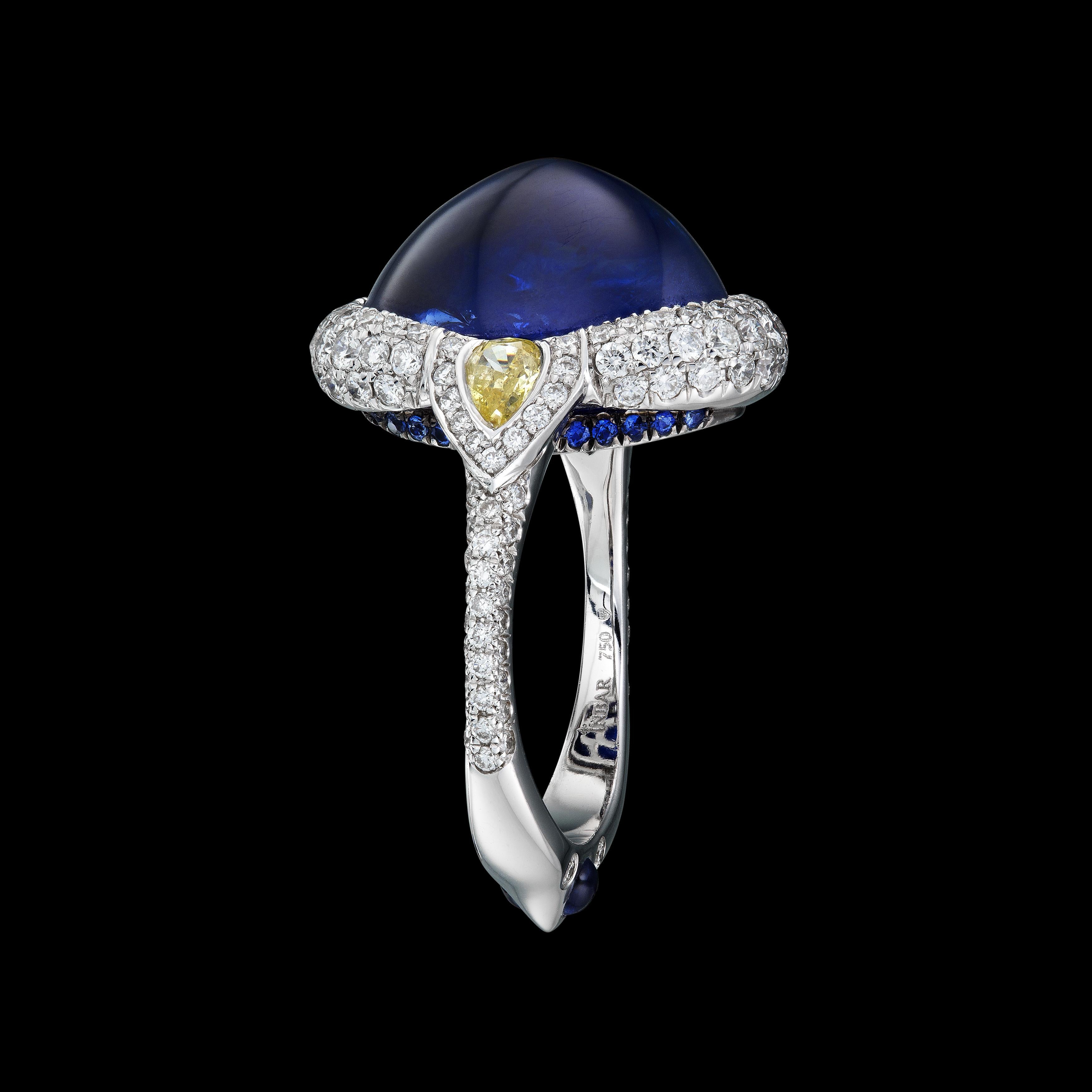 GRS certified 13.57 carat royal blue Suferloaf sapphire ring with white and fancy yellow diamonds, white 18k gold and small sapphires.