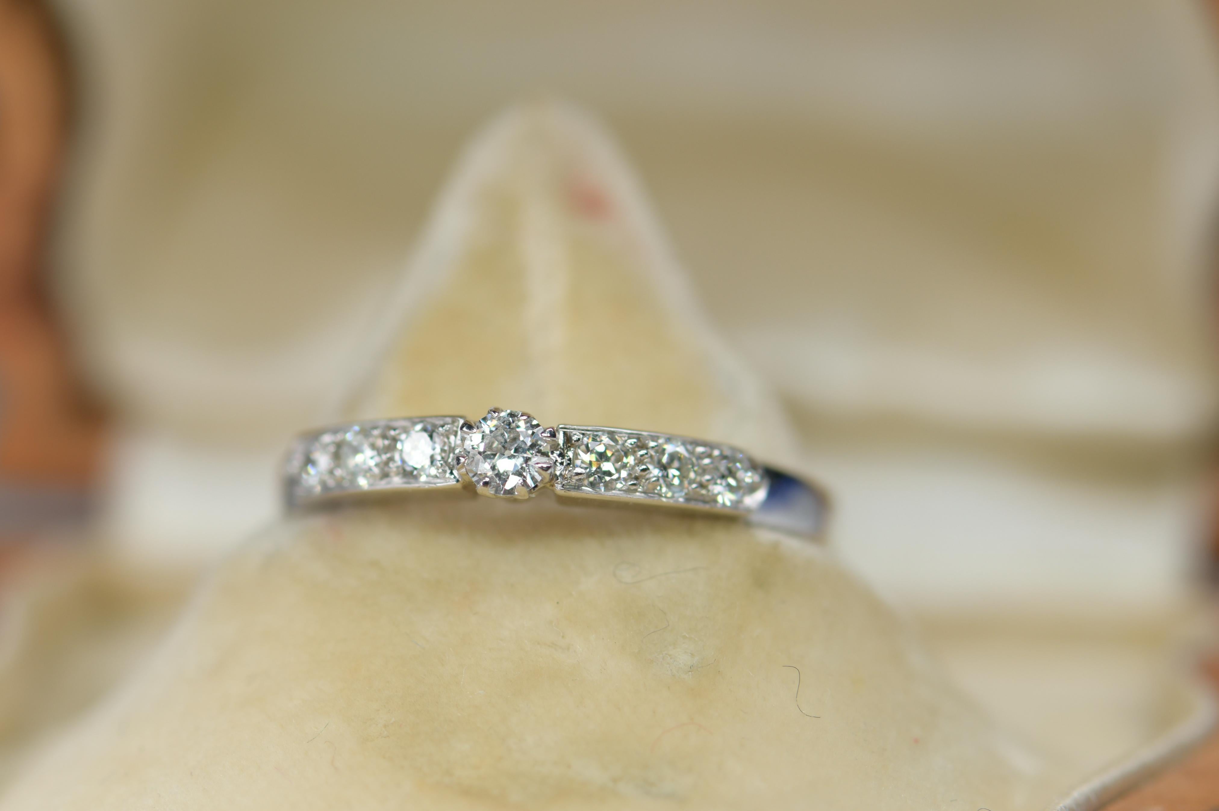 This 18k white gold eternity ring is framed by 0.3 carat of micro-set diamonds around half of the band. Classic and sophisticated, the radiant light reflection from the stones is offset by a smooth polished base.

It is currently a size M (UK), 6.25