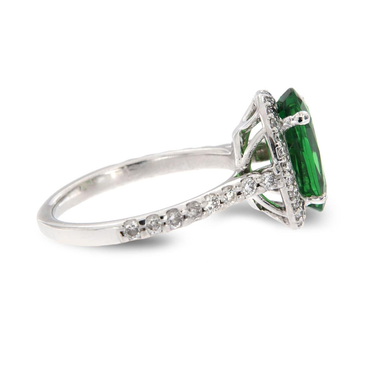 From our signature Gemstones collection of exquisite red carpet pieces, this handcrafted 18k White gold ring is centering a Top Quality Oval shape 2.86 Carat green Tsavorite GIA Certificate 5202148734 in premium luster encircled by a halo of
