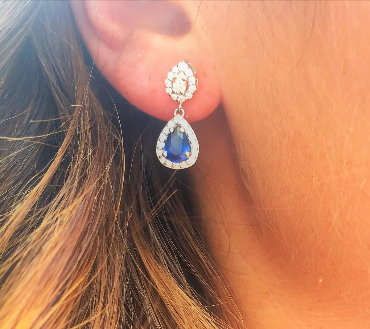 Featuring 18k white gold double halo diamond earrings with pear shape blue sapphire drops 
Sapphire weighing 1.50 carats 
Pear shape diamond weighing 0.50 carats 
Surrounded by pave-set diamonds weight 0.50 carat 
New Earrings
Handmade in USA
The
