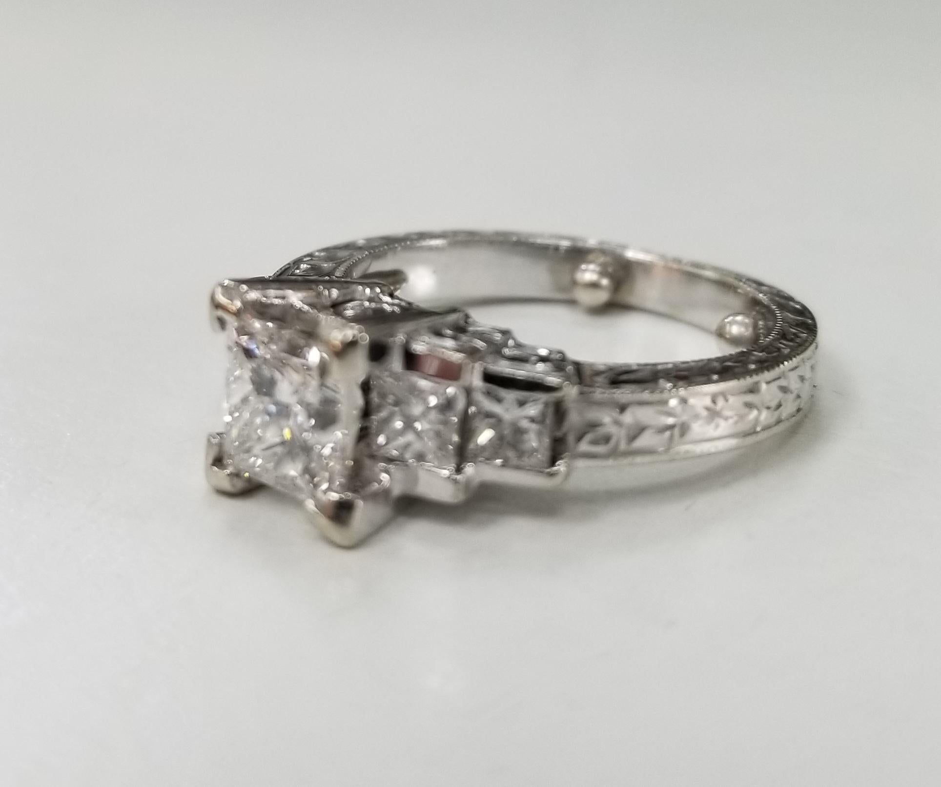 18k white gold hand engraved diamond princess cut ring, containing 1 princess cut diamond; color G, clarity SI and weight .80cts. also 4 princess cut diamonds of very fine quality weighing .50pts. ring size is a 6 and can be sized to fit for free.