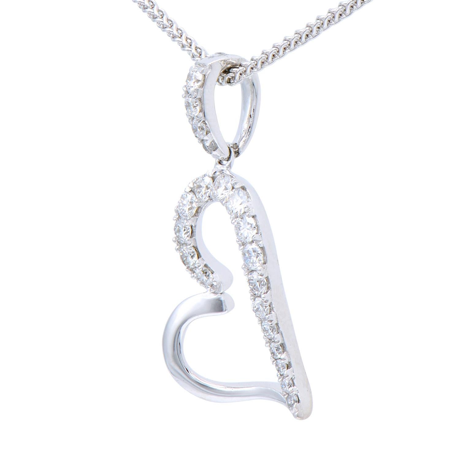 Show your love with this beautiful 18 karat white gold heart necklace enhanced with sparkling stunning diamonds. This pendant contains 20 round VS2, G color diamonds with a total of 0.20 carats which are set in 1.0 gram of 18 karat white gold.