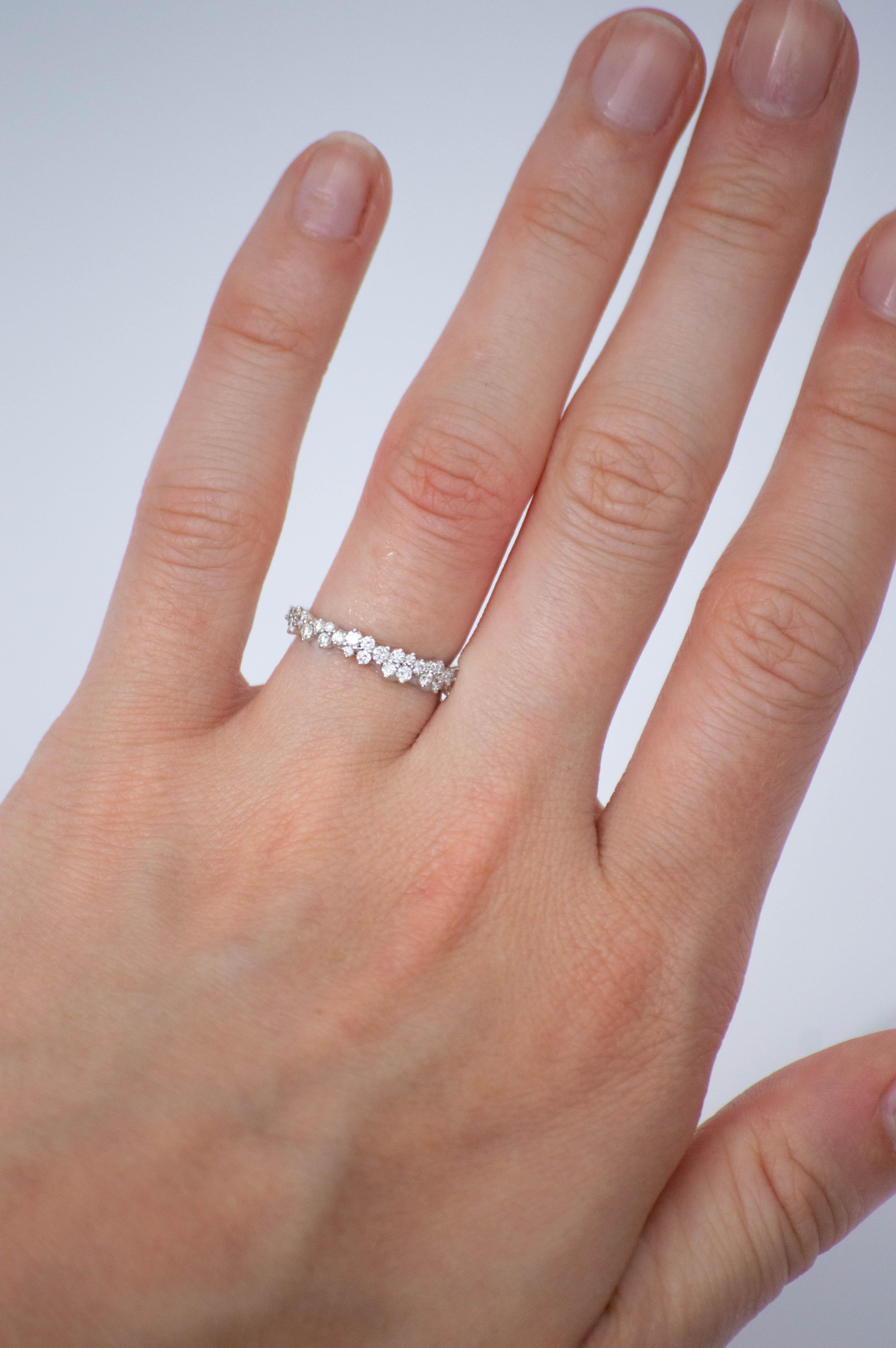 Crafted from premium 18k gold and featuring a classic design of round brilliant diamonds, this band is the perfect choice for those who want to add a touch of understated luxury to their jewelry collection. The diamonds have been expertly cut and