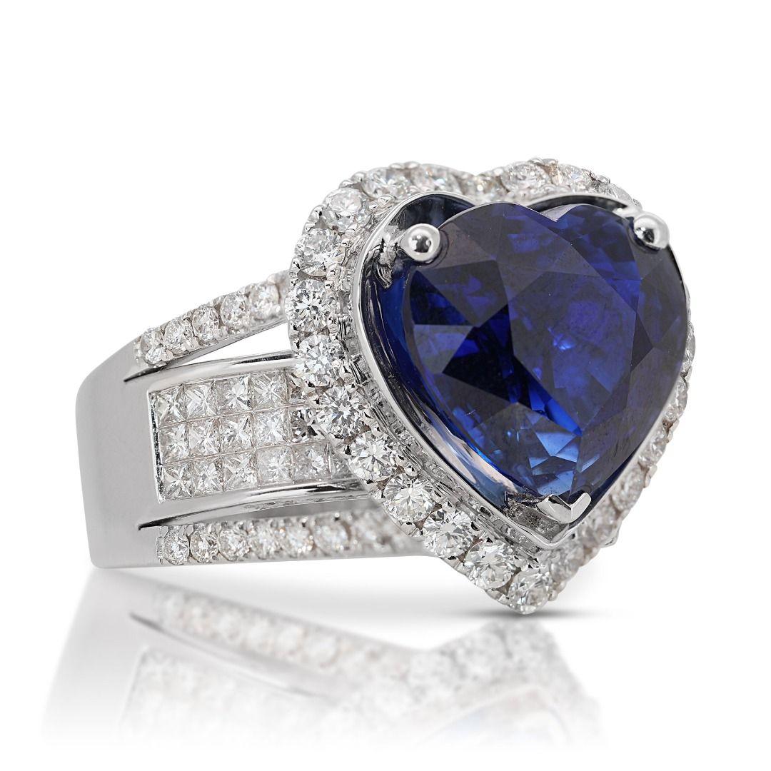 At the heart of this enchanting ring lies a magnificent 8.02-carat heart-shaped sapphire, radiating a captivating blue hue that exudes timeless beauty and grace. With a transparent clarity grade, this sapphire showcases stunning clarity and