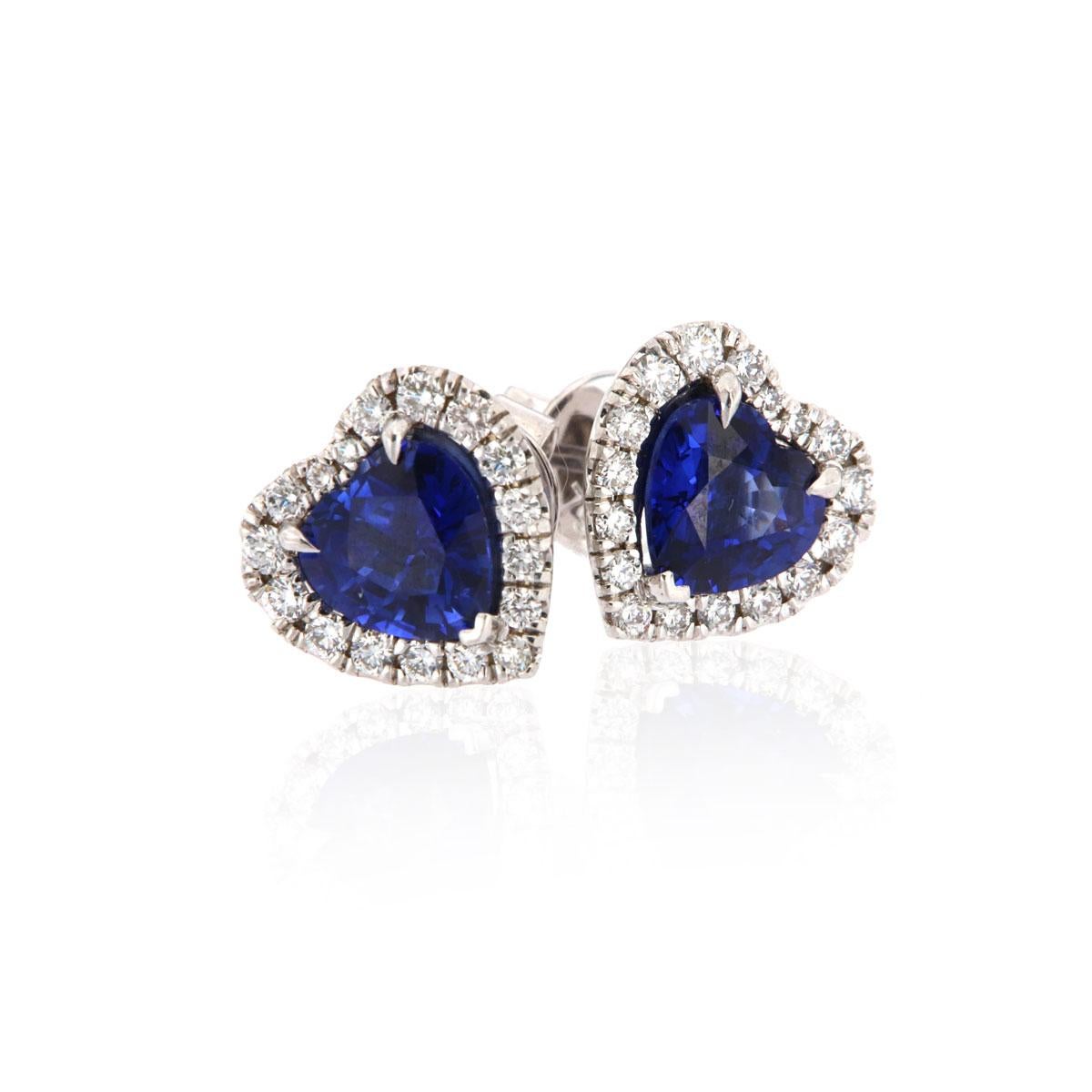 These sparkling halo earrings feature two perfectly matched Heart shape Royal Blue Natural Sapphires in a total weight of 3.13 carat. The sapphires are surrounded by a brilliant halo of micro-prongs diamond accents in a total weight of 0.60 carats.