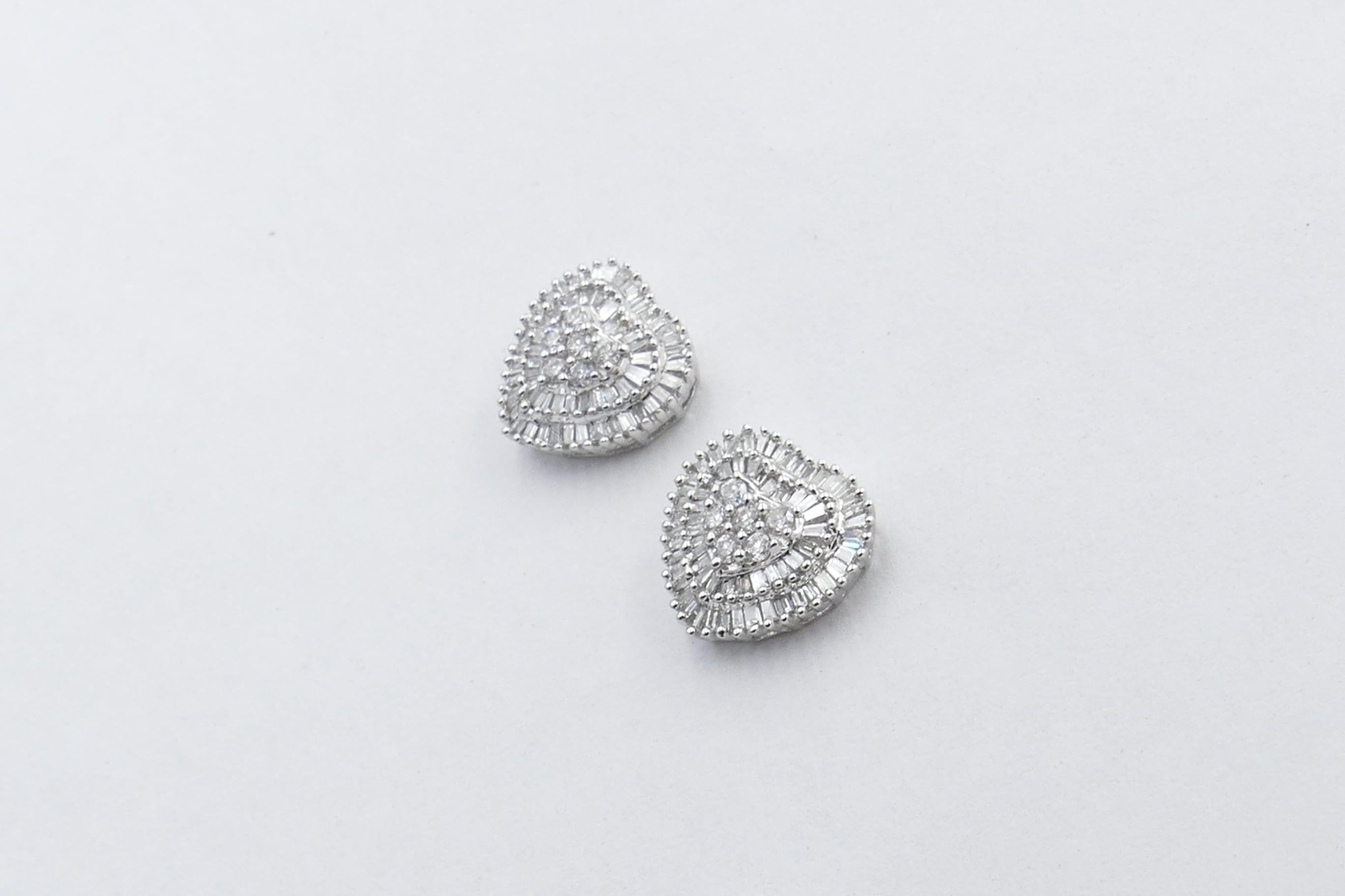 How pretty are these Diamond Hearts.
They have very good quality Diamonds G/H Colour in a combination of round brilliant & baguette cuts and the combined weight is 1 carat. 
They sit beautifully on the ear, are very light to wear and of a really