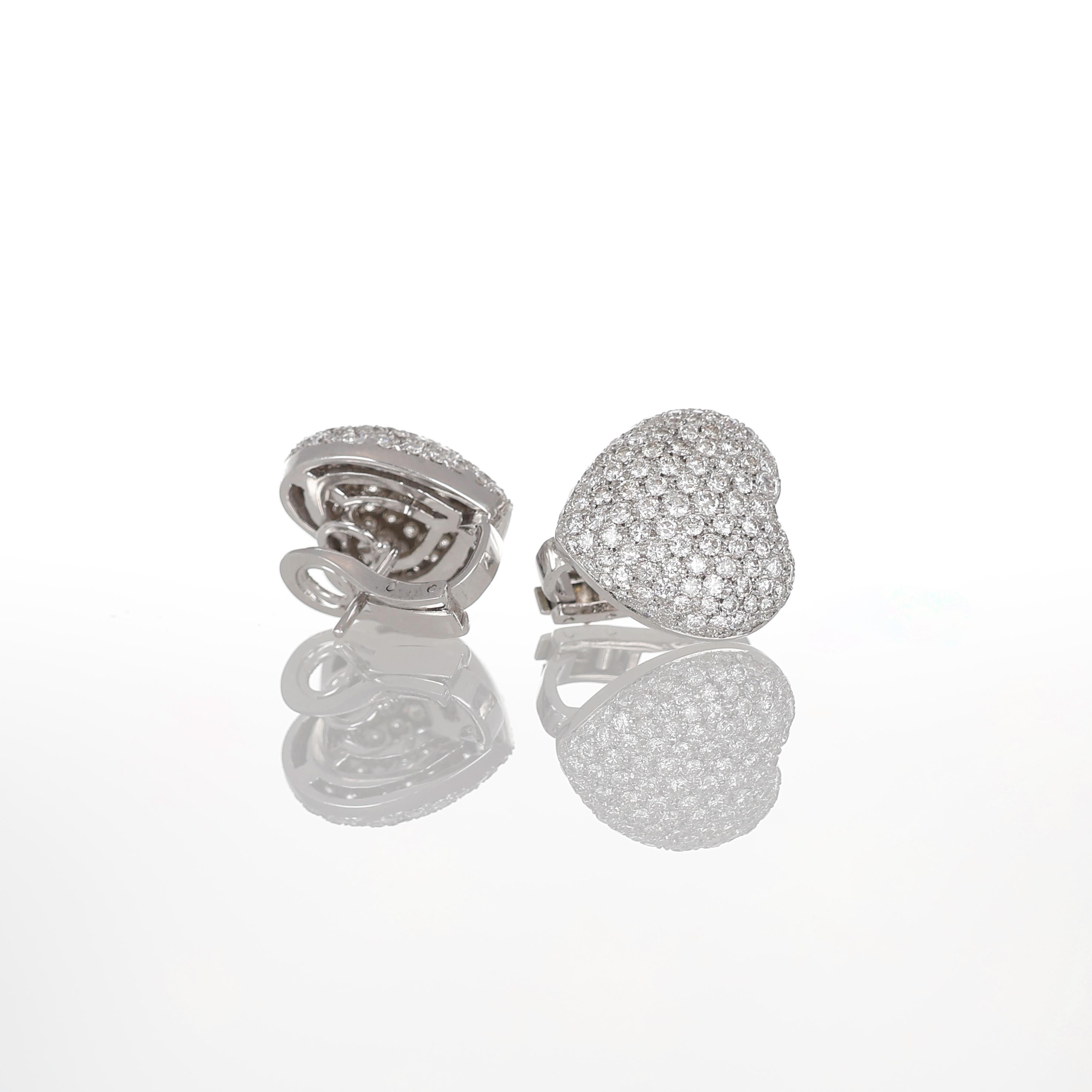 A timeless symbol of elegance and love, these 18K white gold heart-shaped earrings are fully encrusted with pavé-set brilliant-cut diamonds, totaling 3.68 carats. The soft, rounded silhouette enhances the luminous sparkle of the diamonds, creating a