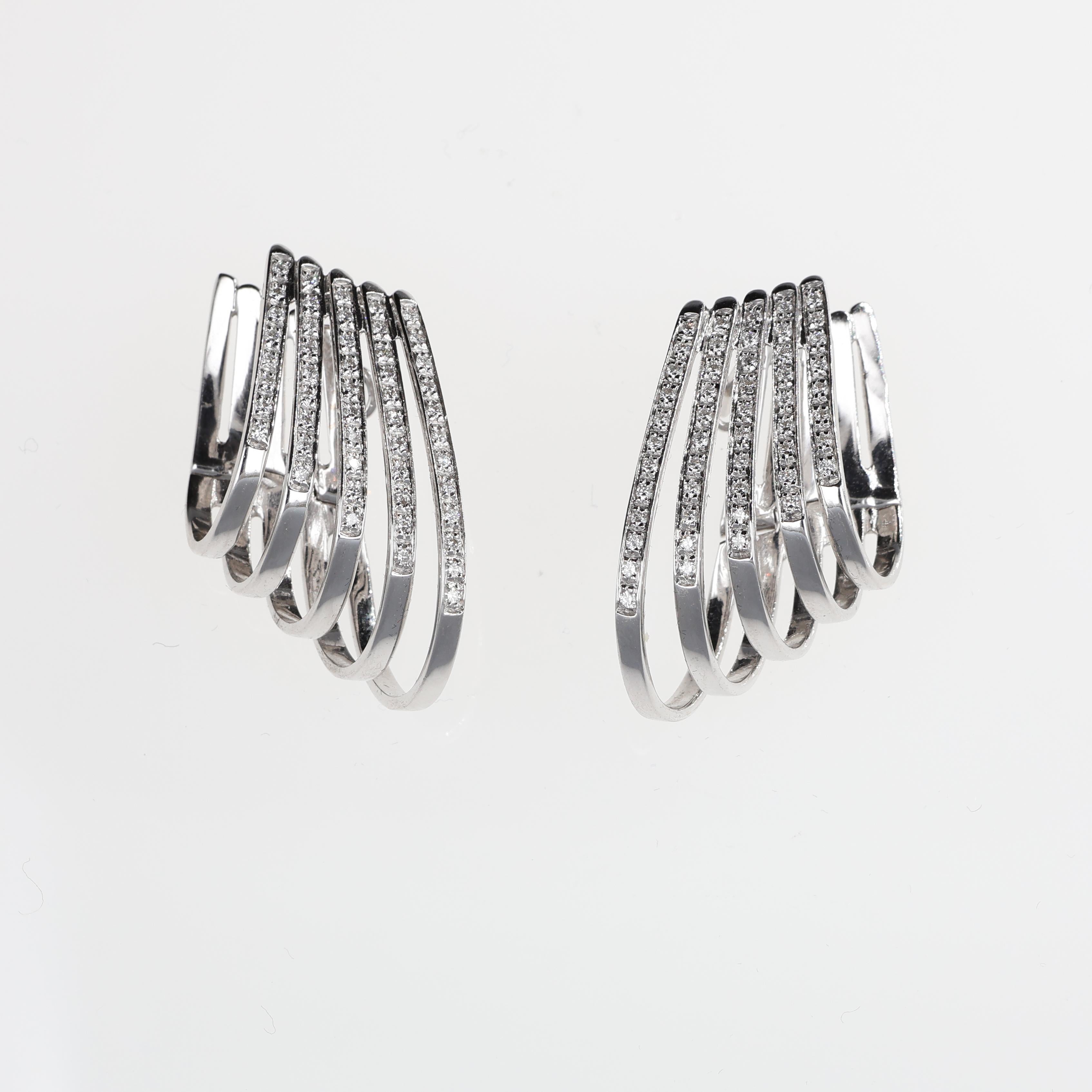 A sophisticated pair of hoop earrings crafted in 18K white gold, featuring a unique design with five cascading rows adorned with brilliant-cut white diamonds. With a total diamond weight of 0.59 carats, these earrings radiate refined elegance and