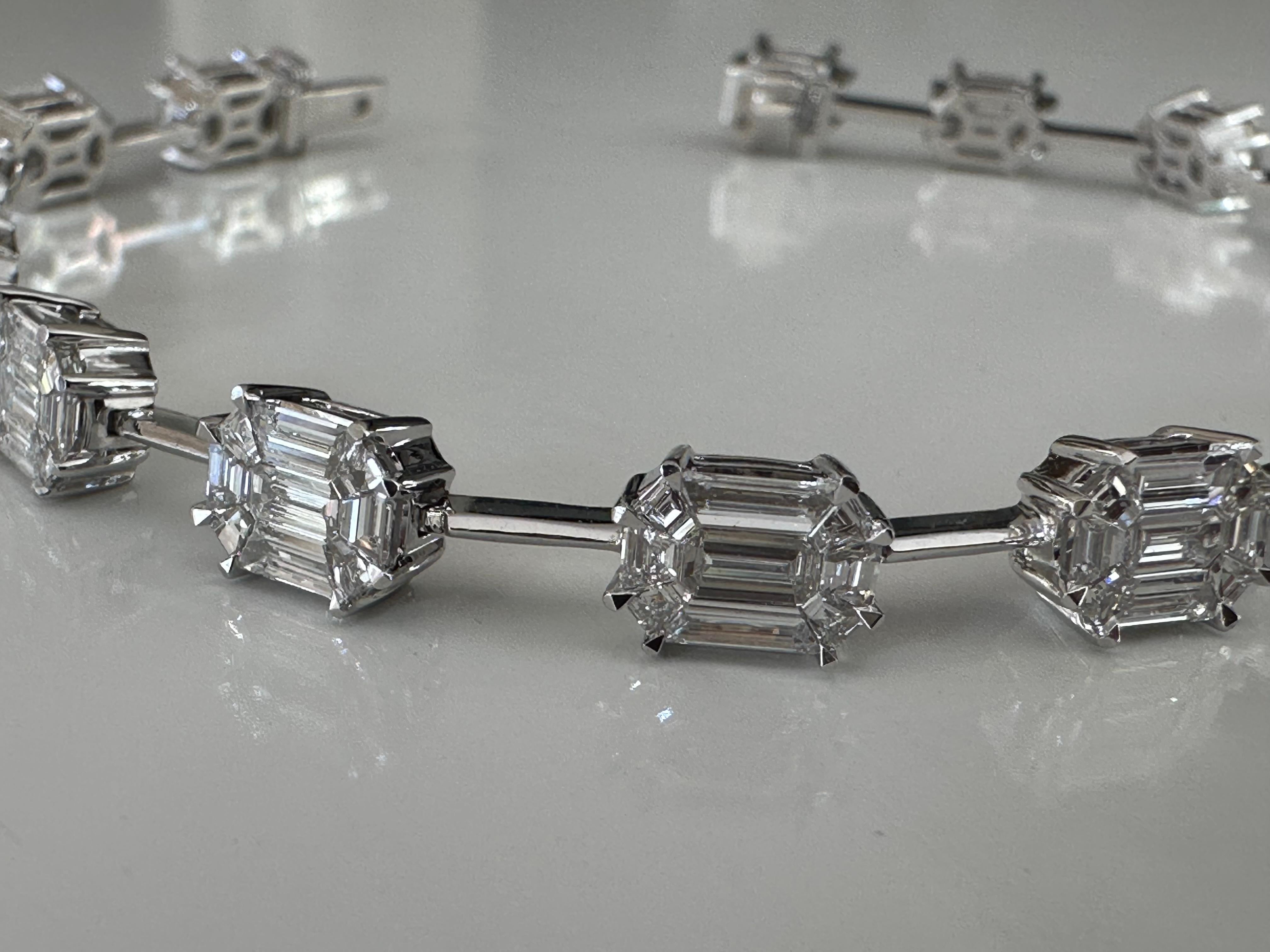 Handcrafted in 18K white gold, this elegant link bracelet features fifteen illusion emerald-cut diamonds (one hundred thirty-five stones in all), highlighting the special technique that uses smaller stones to create the illusion of a larger stone.