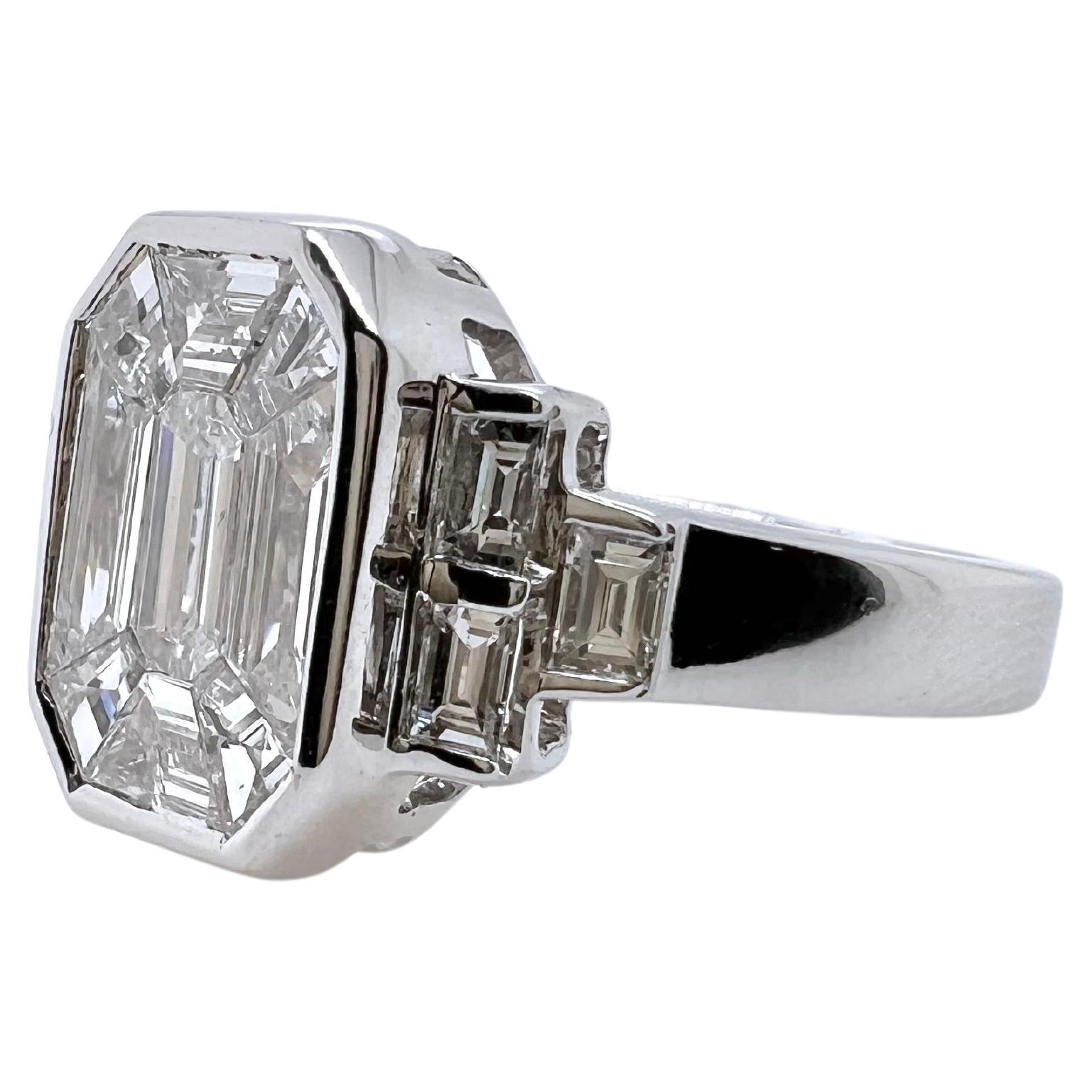This ring is extremely difficult to make and is a piece of art! The center is an illusion of a larger emerald cut diamond but in fact, is comprised of baguettes and a smaller emerald cut. The baguettes are specifically cut to fit perfectly like a