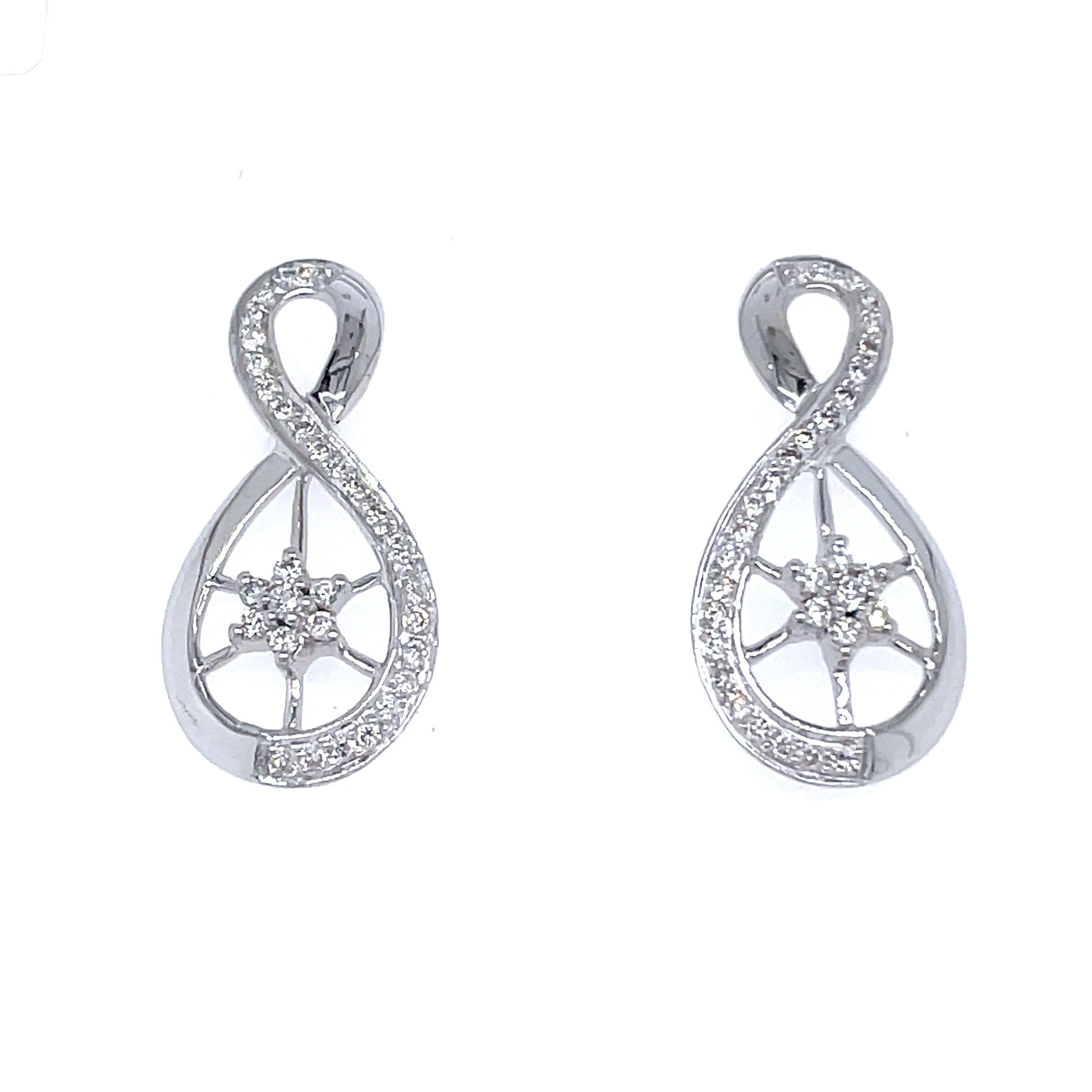18k White Gold Infinity Diamond Earrings

Fashioned from 18k white gold, boasting a substantial weight of 4.90 grams, these earrings are more than mere adornments; they are a declaration of opulence. 

The resplendent white gold setting serves as