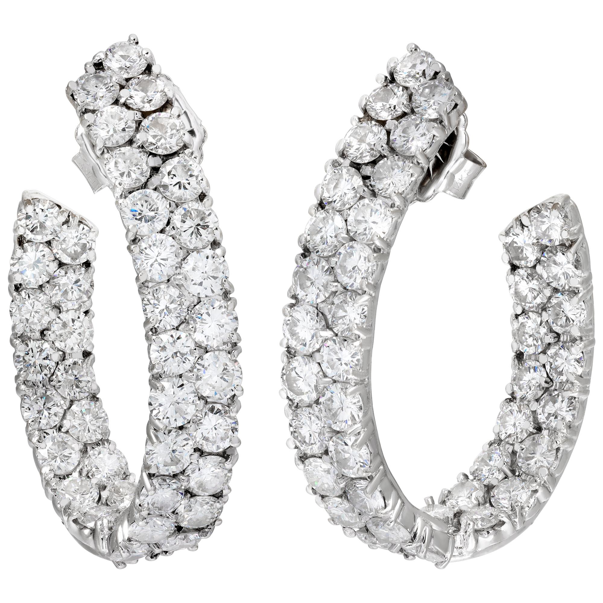 Inside out oval shape hoop earrings with double row of diamonds in 18k white gold. Round brilliant cut diamonds total approx. weight: 12.00 carats, estimate: G-H Color VS/SI clarity. Hanging length 40mm x 6mm width (1.50 x 0.25 inch).
