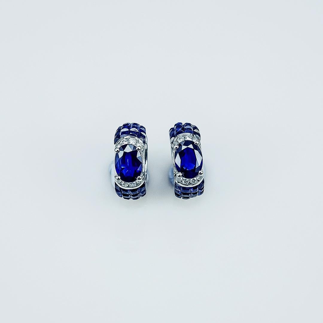 A small cute hoop made in sapphire .The oval sapphire is a very nice color. We use the top quality Sapphire which make in invisible setting. We set the stone in perfection as we are professional in this kind of setting more than 40 years. The