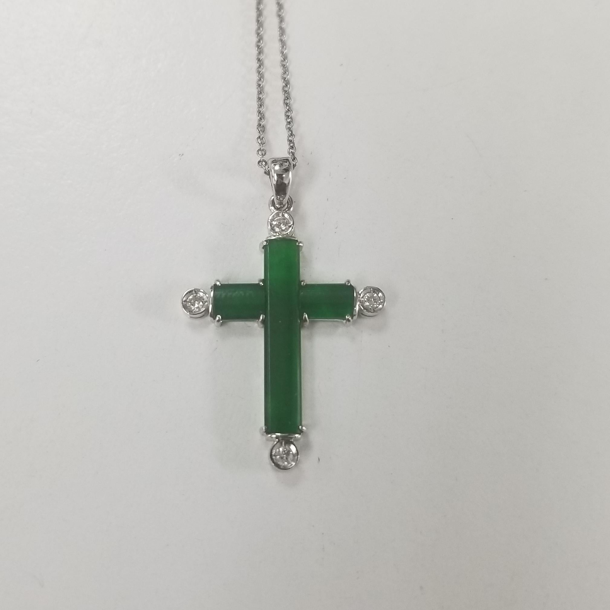 This beautiful Vintage 18k white gold jade and diamonds cross, containing 
3 pieces of jade and 4 round diamonds weighing .10pts. on a 16 inch 14k white gold chain. 3.5grams
     